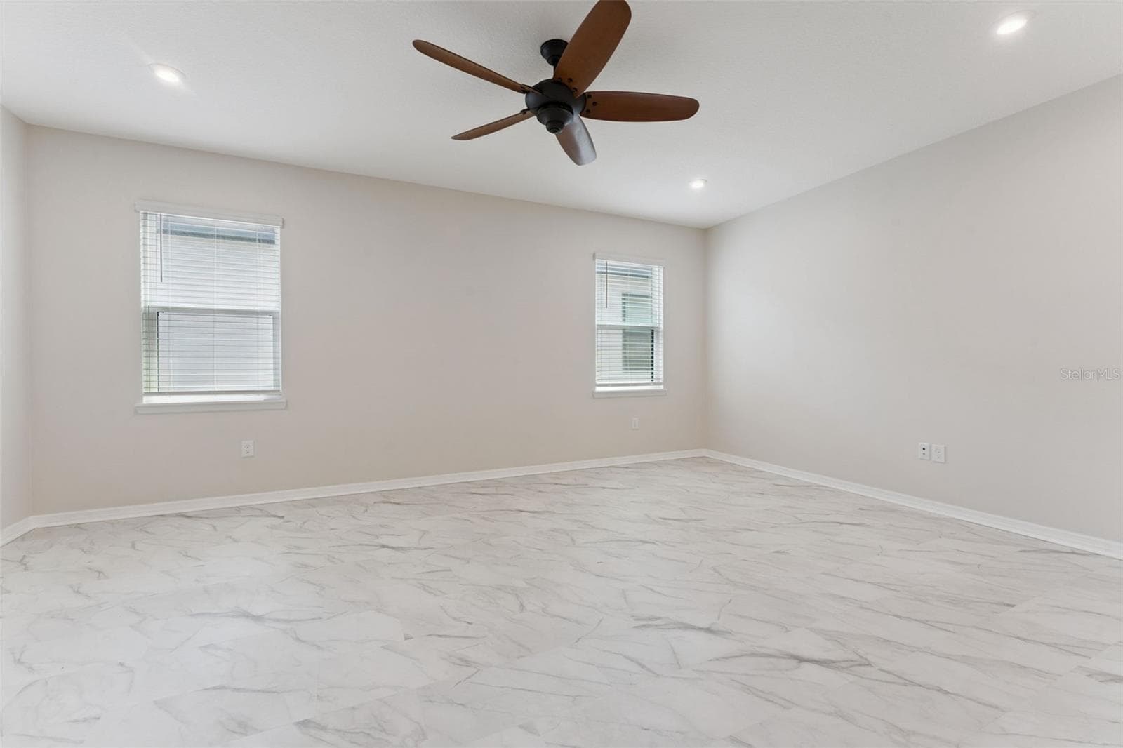 Bonus Room – A second angle highlights the generous open floor area and multiple windows that bring natural light into this versatile upstairs retreat. - 1287 VERDANT GLADE PL, WINTER PARK