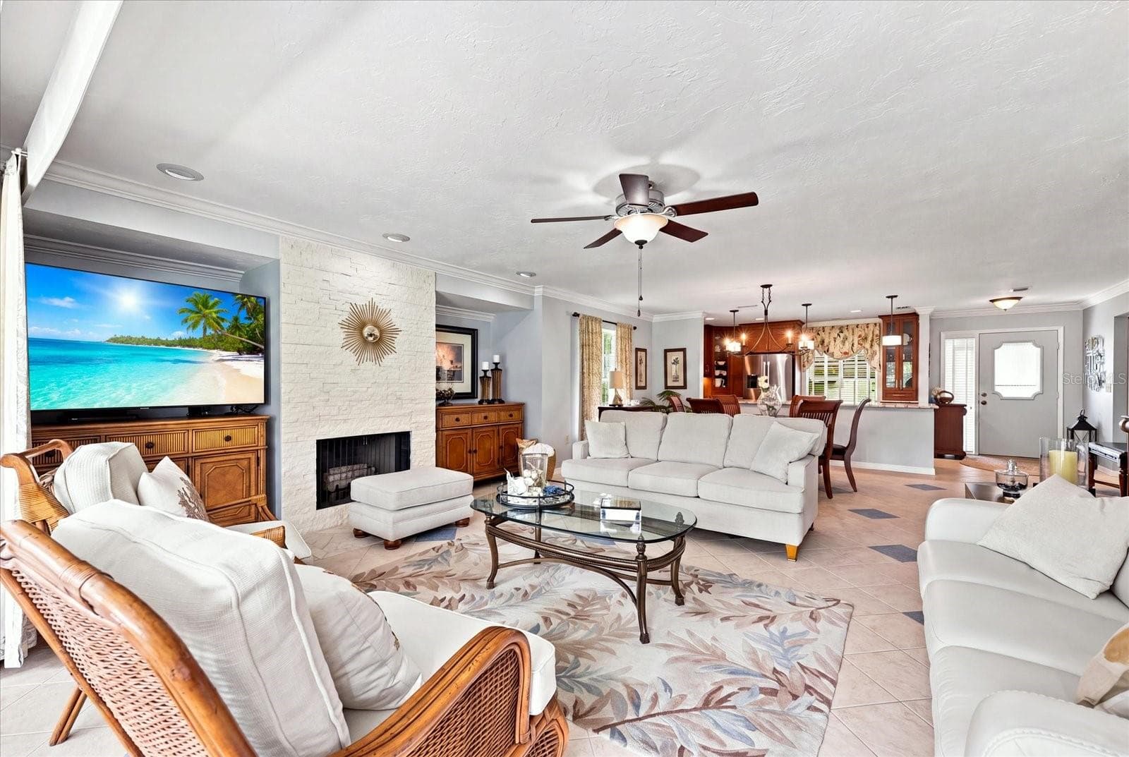 Large living room offering an updated fireplace highlighted by neutral stacked stone. - 3252 RINGWOOD MDW #81, SARASOTA