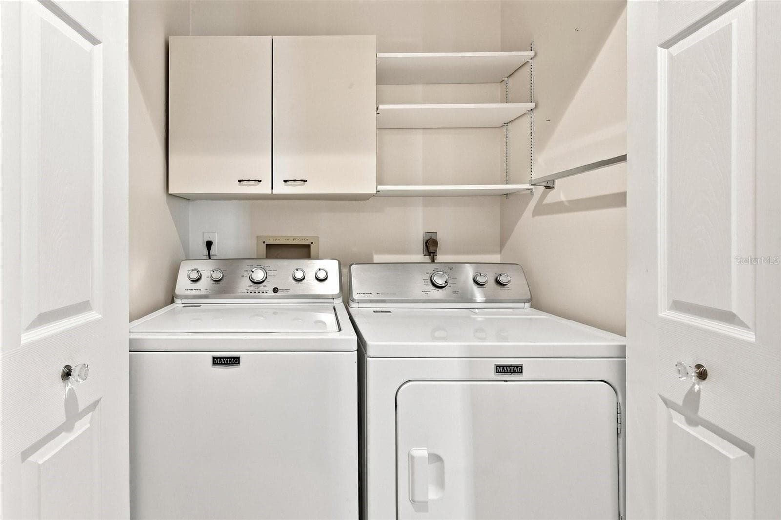 Inside laundry and extra storage cabinets and shelving. - 3252 RINGWOOD MDW #81, SARASOTA