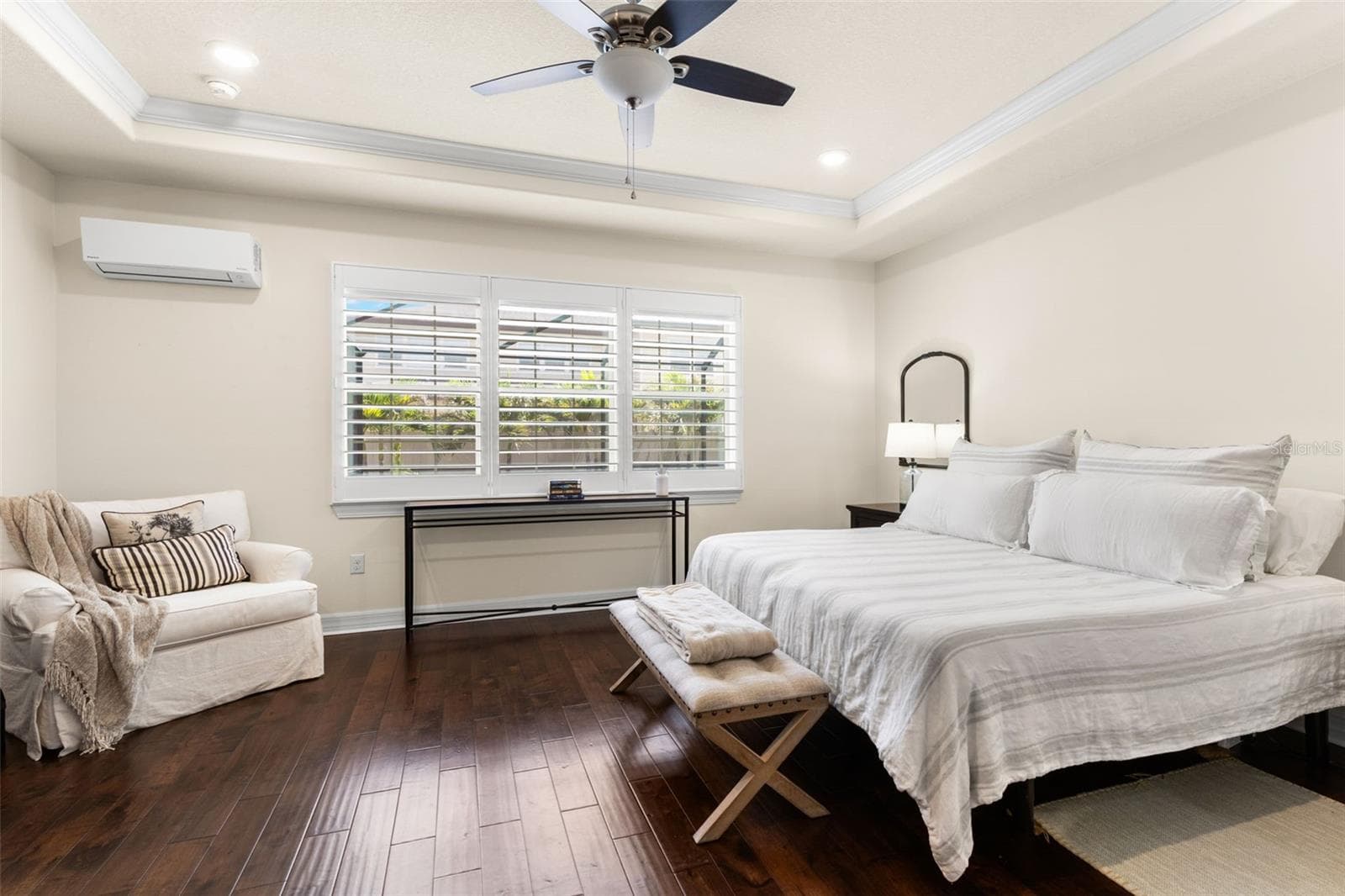 The primary bedroom feels like a retreat of its own, with rich engineered hardwood floors, a tray ceiling with crown molding, a ceiling fan, plantation shutters, and generous proportions that easily accommodate a sitting area. A recently added mini-split A/C provides an extra level of individualized comfort. - 1528 FOREST GLEN CT, PALM HARBOR
