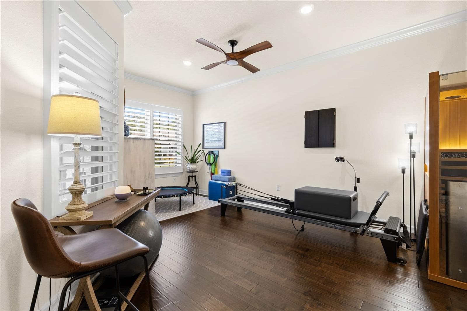 Just off the foyer, a generously sized French-door flex room adds valuable versatility to the floor plan. Engineered hardwood floors, crown molding, plantation shutters and a ceiling fan create a polished backdrop for a home office, fitness studio, media room, hobby space or additional sitting room. - 1528 FOREST GLEN CT, PALM HARBOR