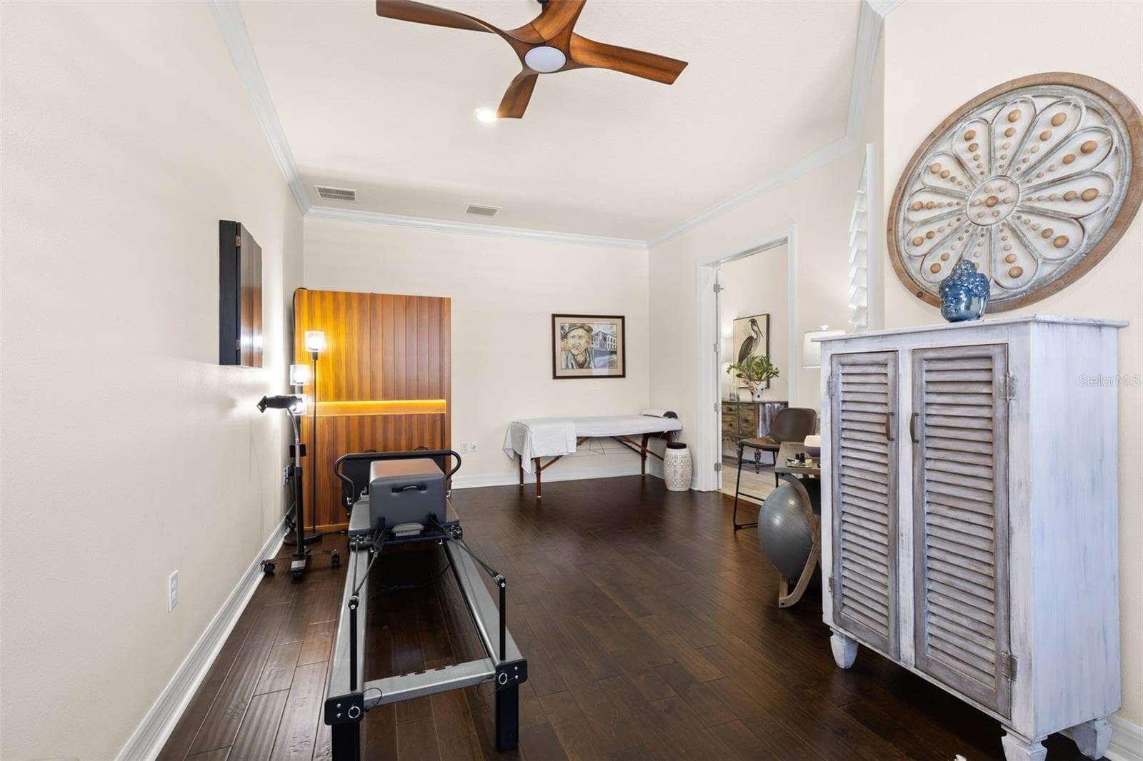 Just off the foyer, a generously sized French-door flex room adds valuable versatility to the floor plan. Engineered hardwood floors, crown molding, plantation shutters and a ceiling fan create a polished backdrop for a home office, fitness studio, media room, hobby space or additional sitting room. - 1528 FOREST GLEN CT, PALM HARBOR