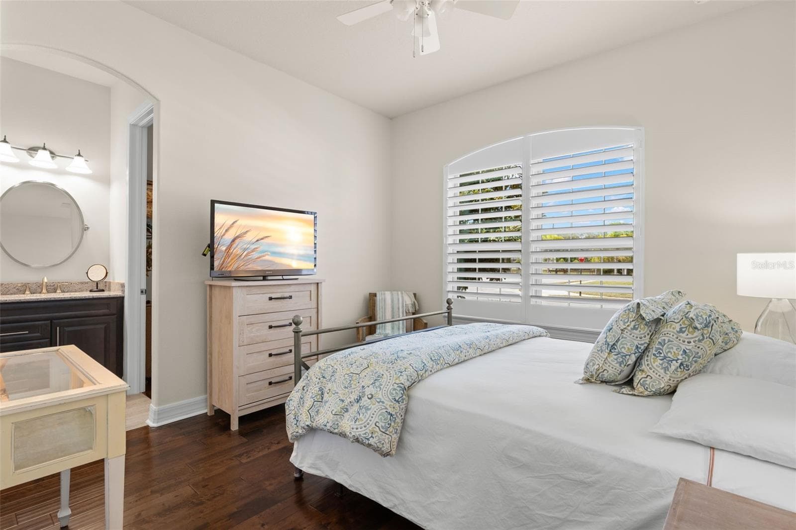 Bedroom 2 connects directly to the Jack-and-Jill bath, with its own separate vanity area just beyond the doorway — a smart layout that gives the room added function and privacy while keeping the shared bath easily accessible. - 1528 FOREST GLEN CT, PALM HARBOR
