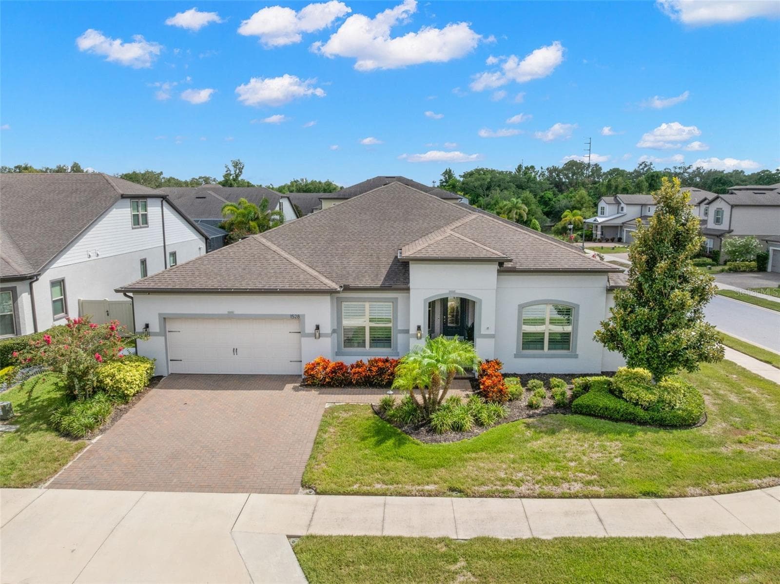 Set on a beautifully landscaped corner lot in the gated Enclave at Palm Harbor, the home’s single-story design, brick-paver driveway, two-car garage and graceful arched entry create a polished sense of arrival from every angle. - 1528 FOREST GLEN CT, PALM HARBOR