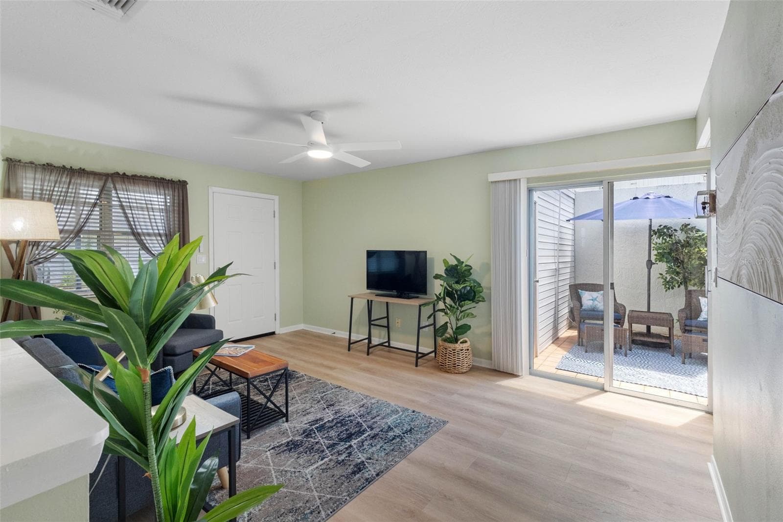 Living room with new ceiling fan - 2833 ORANGE TREE CIR N #A, PALM HARBOR
