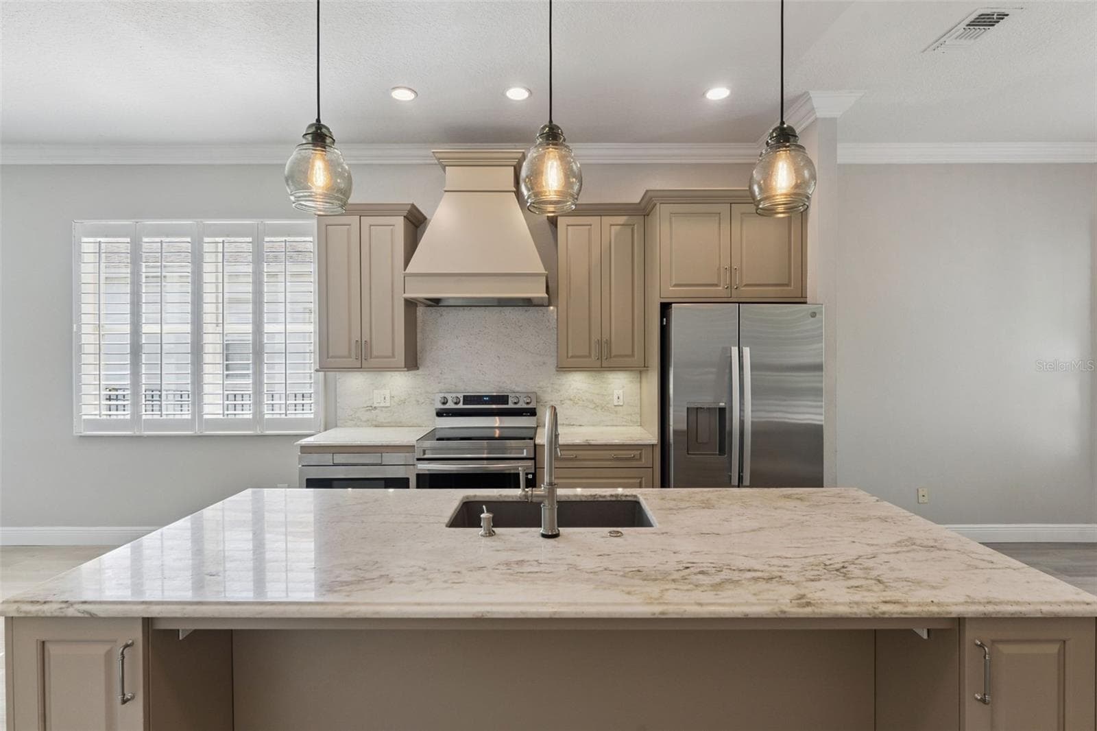 Room for counter stools at kitchen island, 3 pendant lights over island and new appliances (2026) - 1206 CHESSINGTON CIR, LAKE MARY