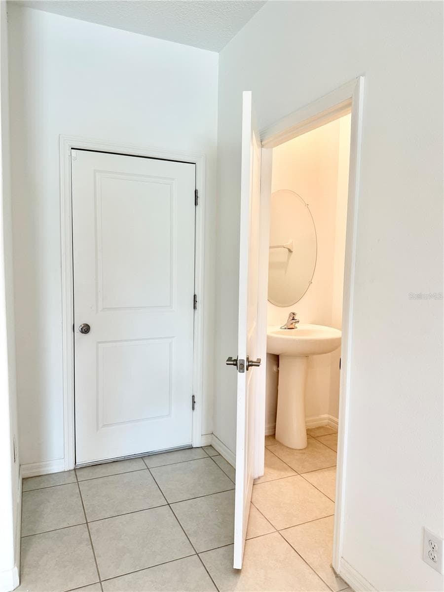1/2 bath in living room next to garage entry door - 2578 CHARLAN CT, HOLIDAY
