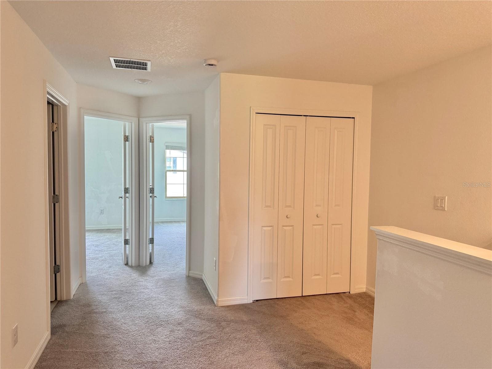 Hall at top of stairs with guest bath entry and entry to two guest bedrooms - 2578 CHARLAN CT, HOLIDAY