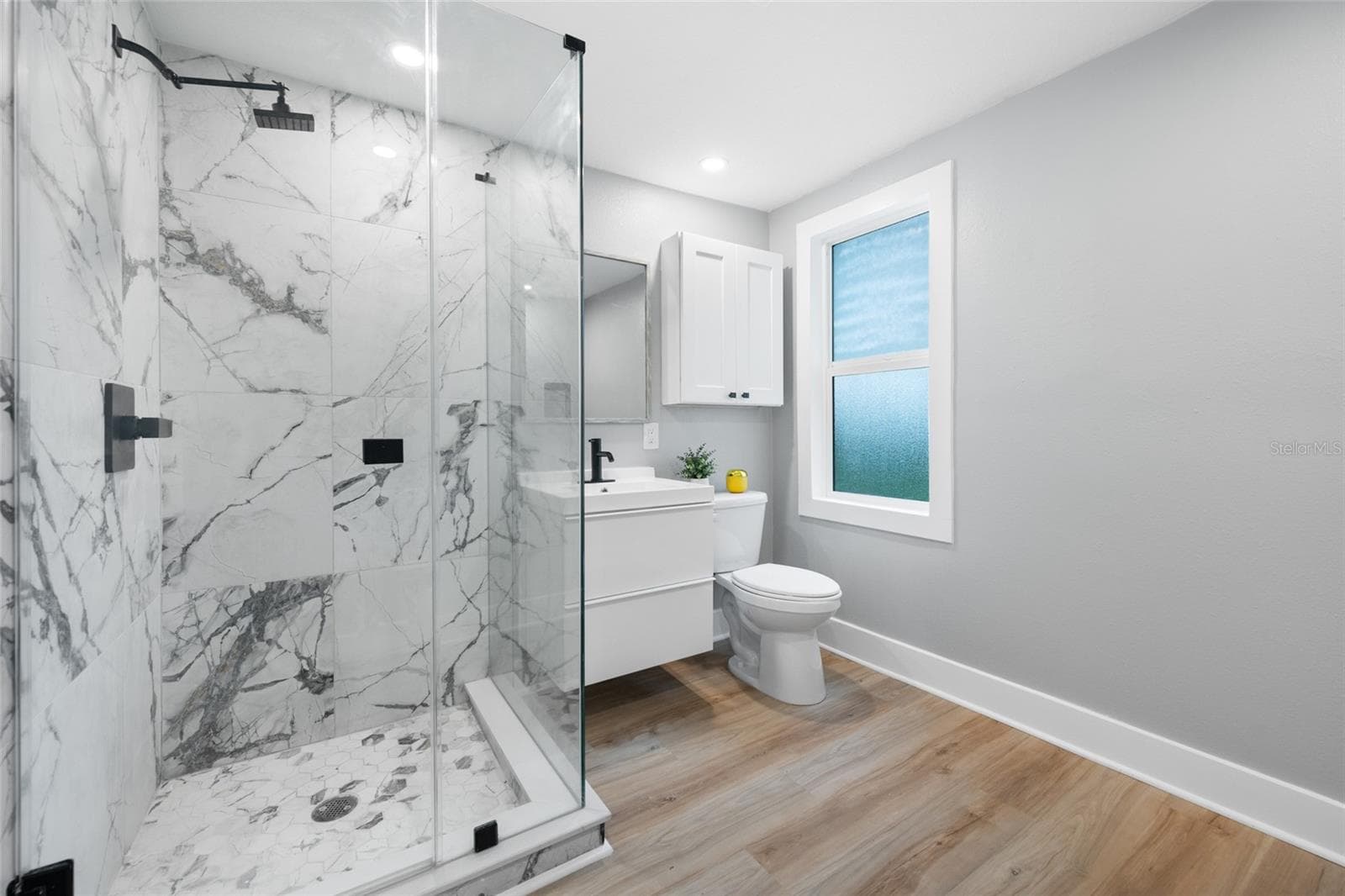 Bathroom with glass enclosed shower and convenient laundry. - 2547 KINGSTON ST S, ST PETERSBURG