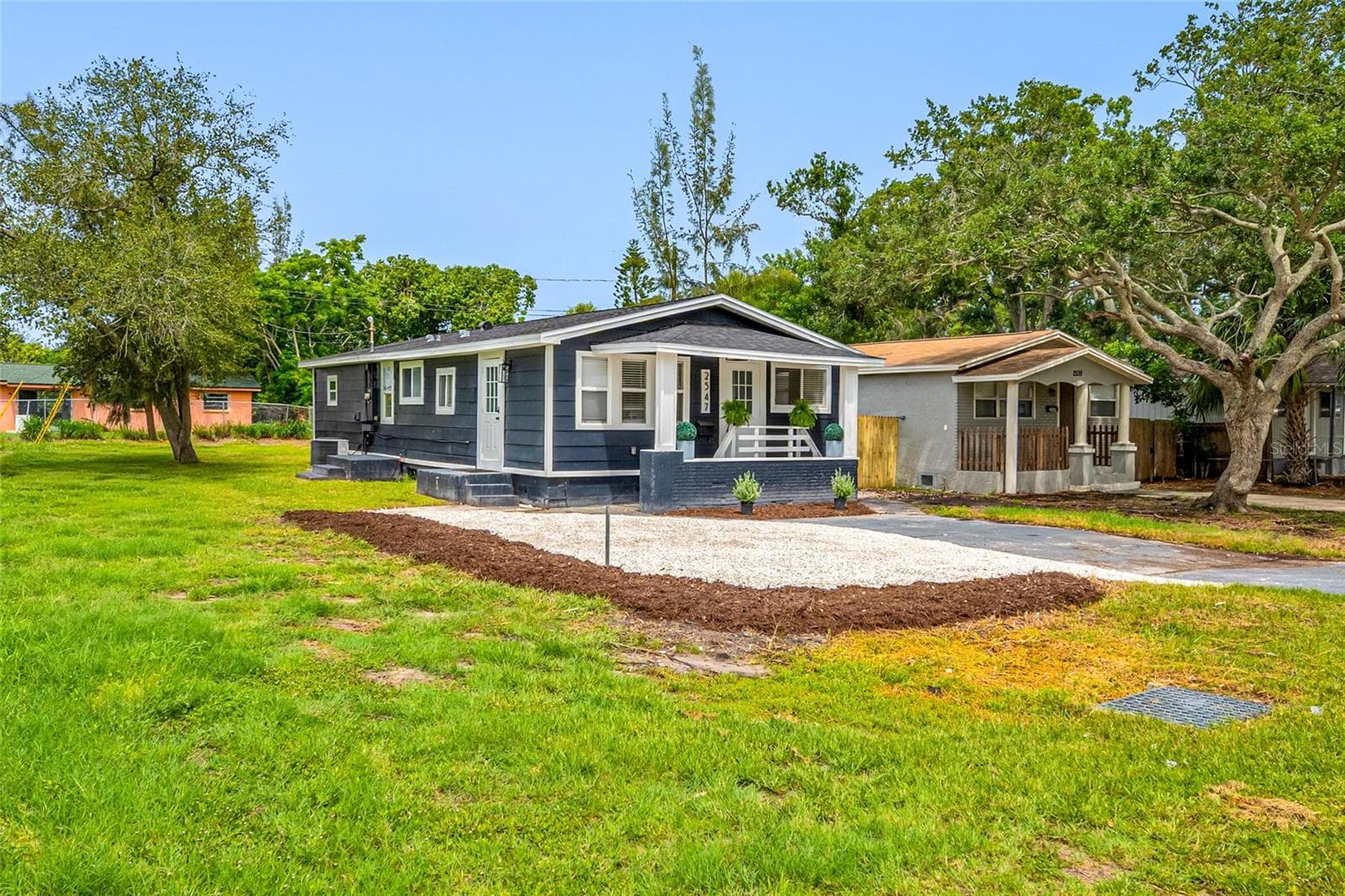 Front view of home with large driveway and lots of guest parking. - 2547 KINGSTON ST S, ST PETERSBURG