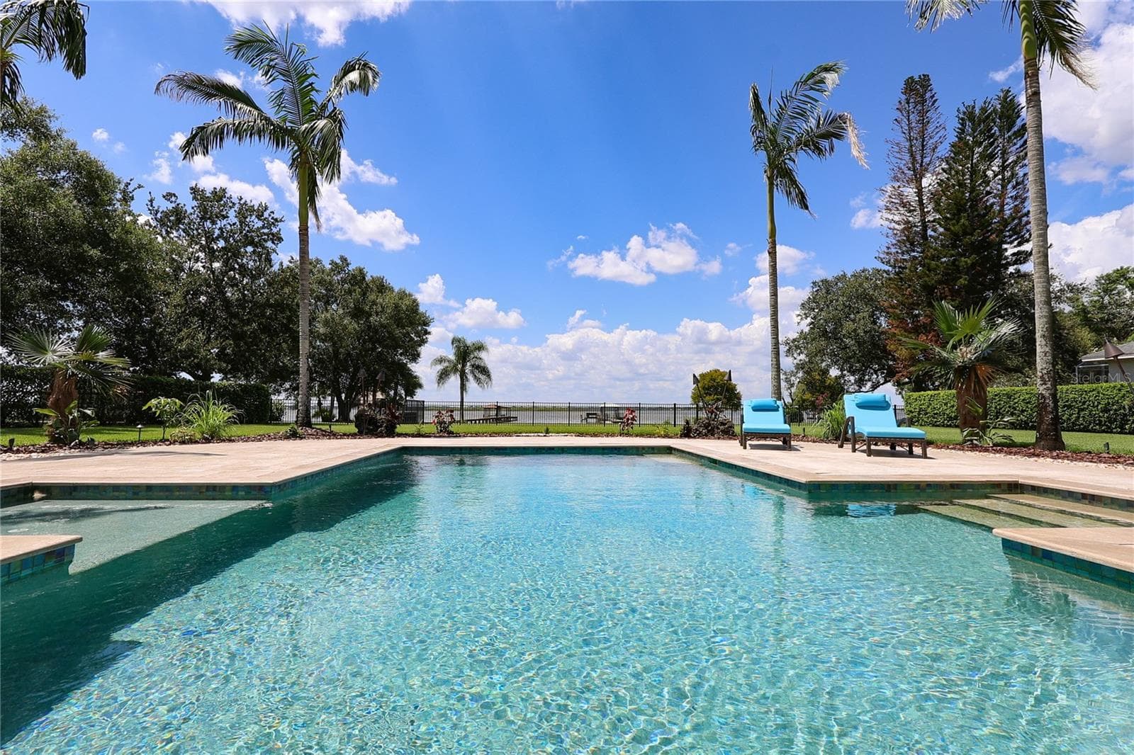 Salt water PebbleTec  pool surrounded by travertine deck. (Propane heated) - 3640 CRUMP RD, WINTER HAVEN