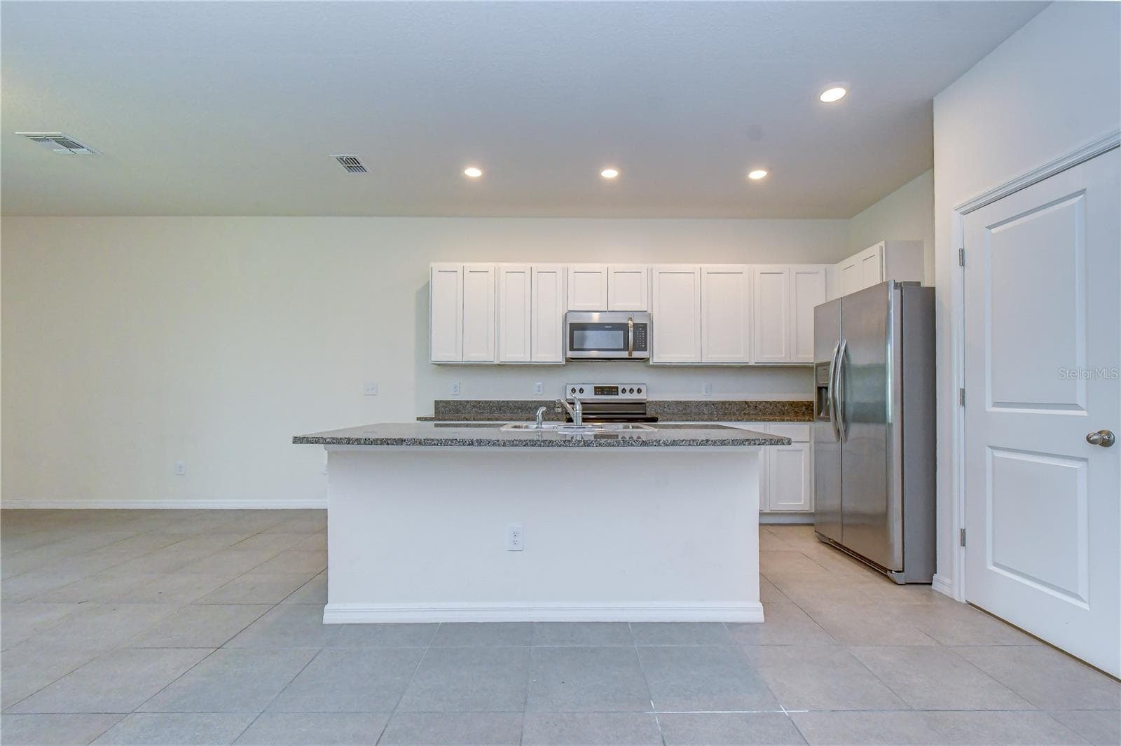 Modern kitchen featuring stone countertops, stainless steel appliances, and abundant cabinetry - 3326 PLEASANT WILLOW CT, BRANDON