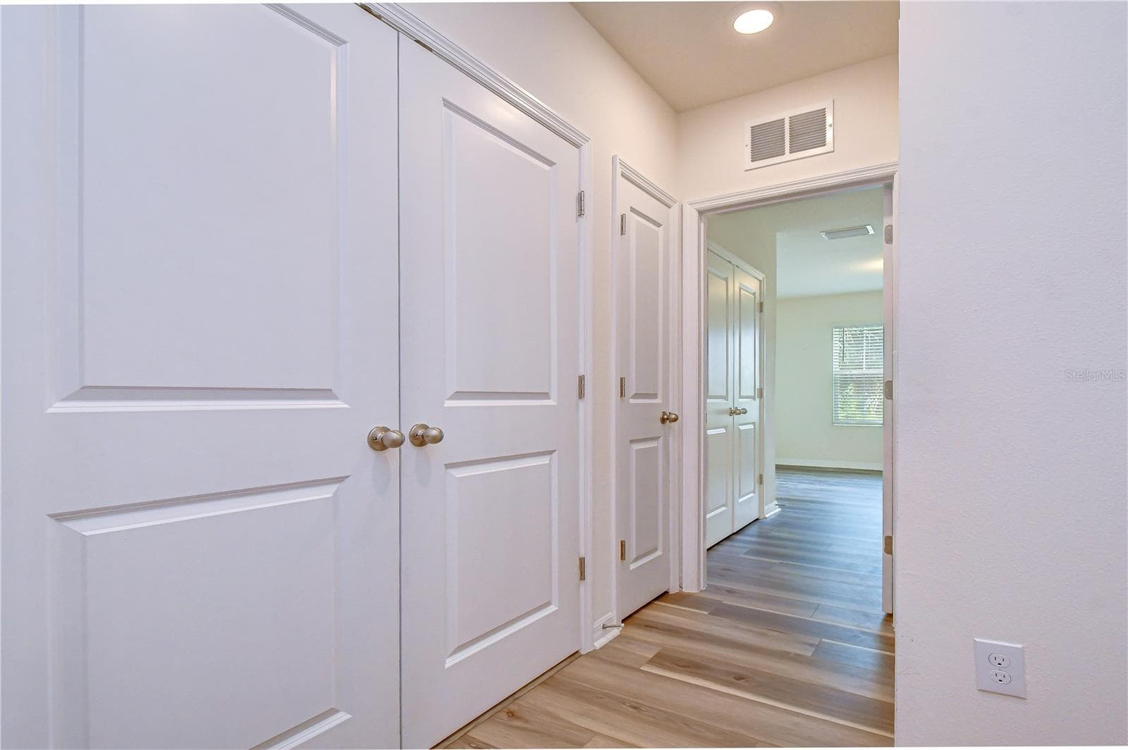 Spacious bedroom with sleek LVP flooring and dual closets for optimal storage. - 3326 PLEASANT WILLOW CT, BRANDON