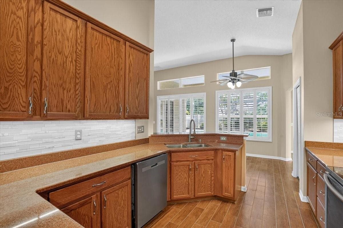 Kitchen looking at pool and eating area - 2309 SWORDFISH AVE, HOLIDAY