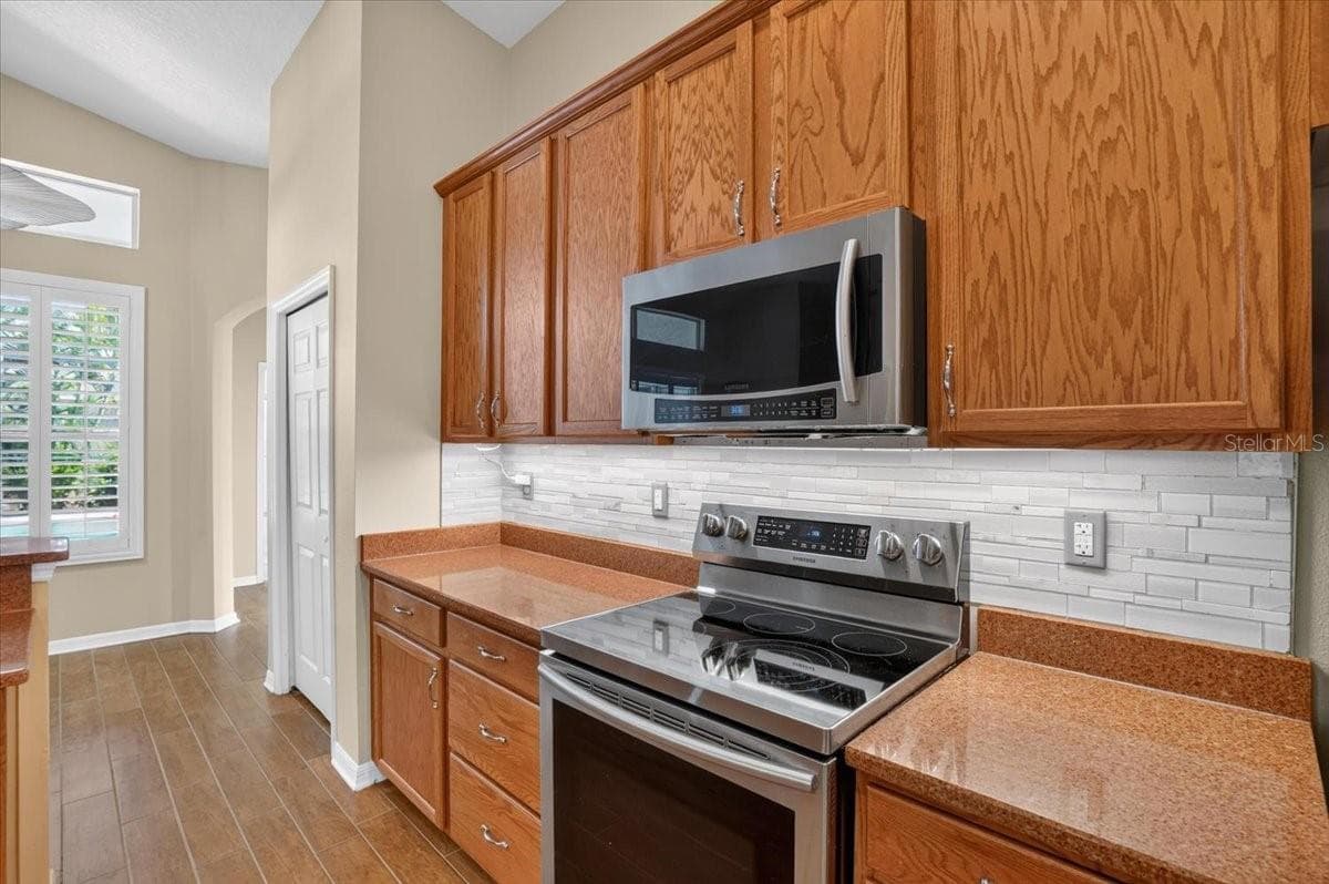 Kitchen looking towards beroom 4 and exit to pool and bathroom 3. - 2309 SWORDFISH AVE, HOLIDAY