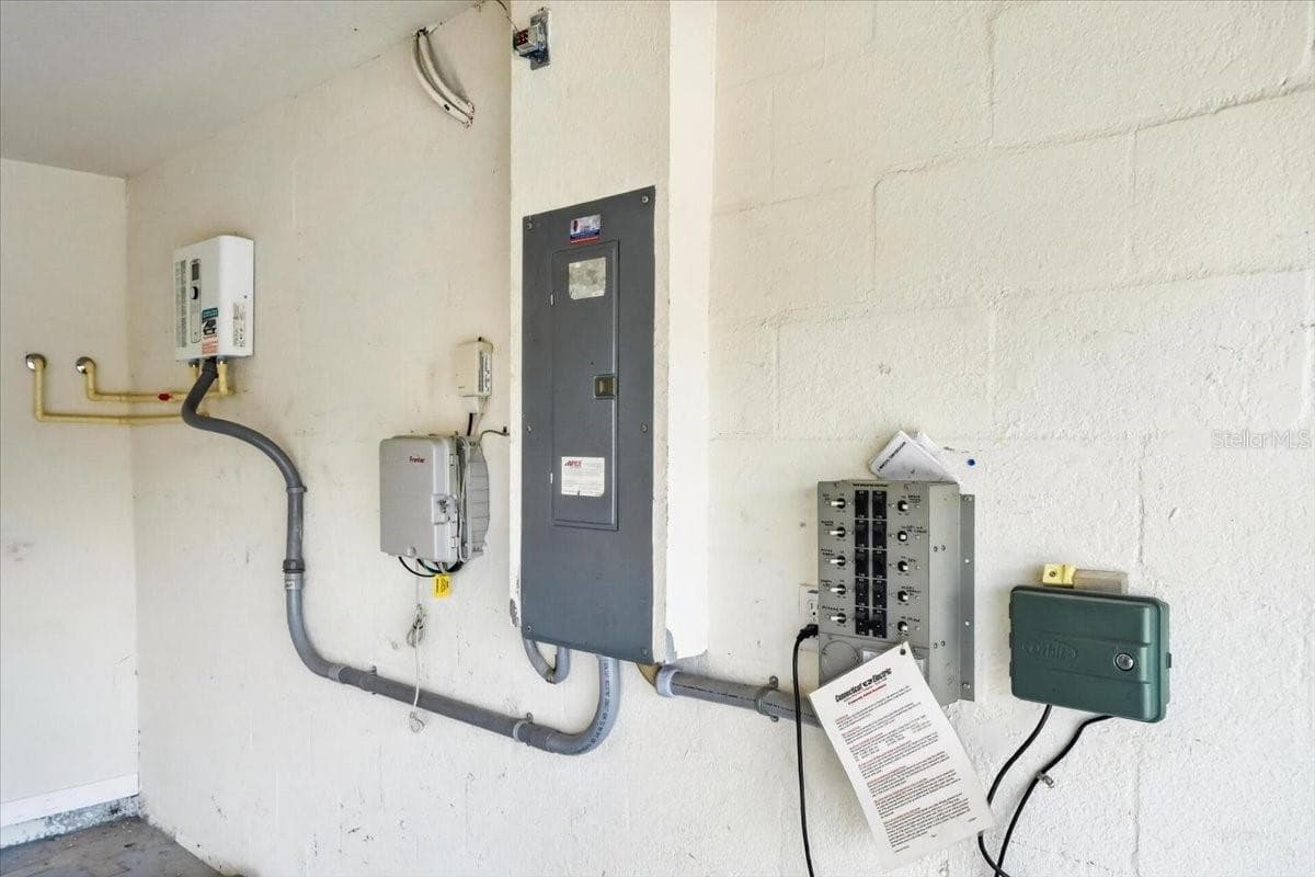 Electrical box that connects to generator, sprinkler system control, and tankless water heater in the garage - 2309 SWORDFISH AVE, HOLIDAY