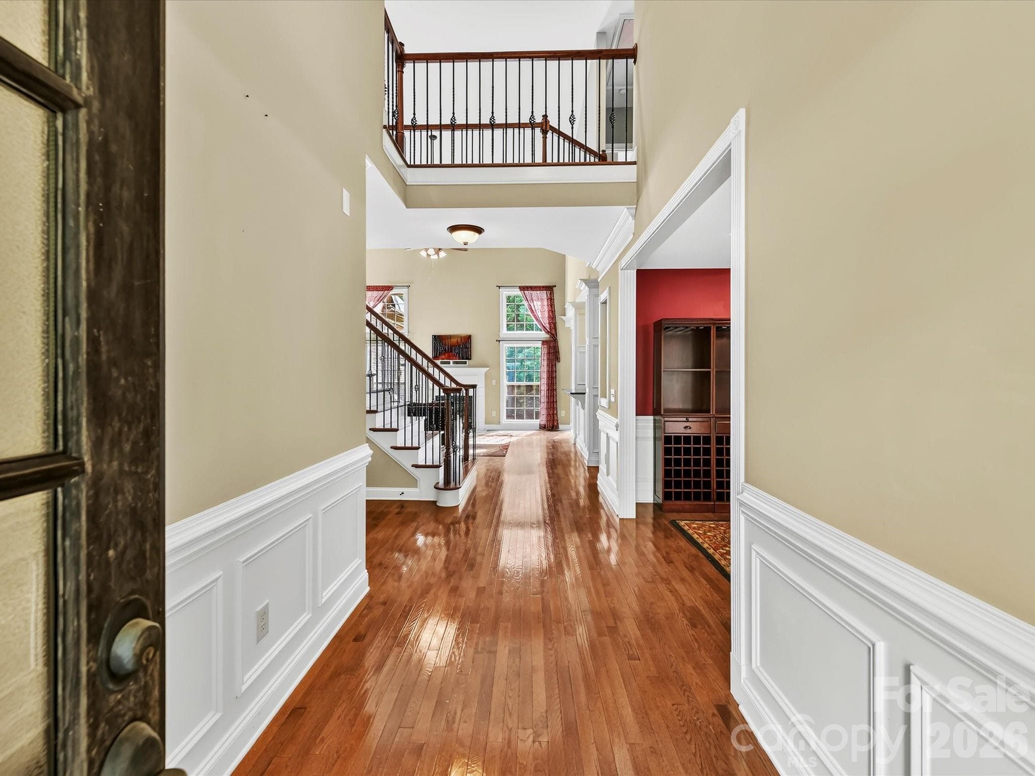 A bright two-story foyer with hardwood floors, detailed millwork, and abundant natural light welcomes you inside. - 11203 Warfield Avenue, Huntersville