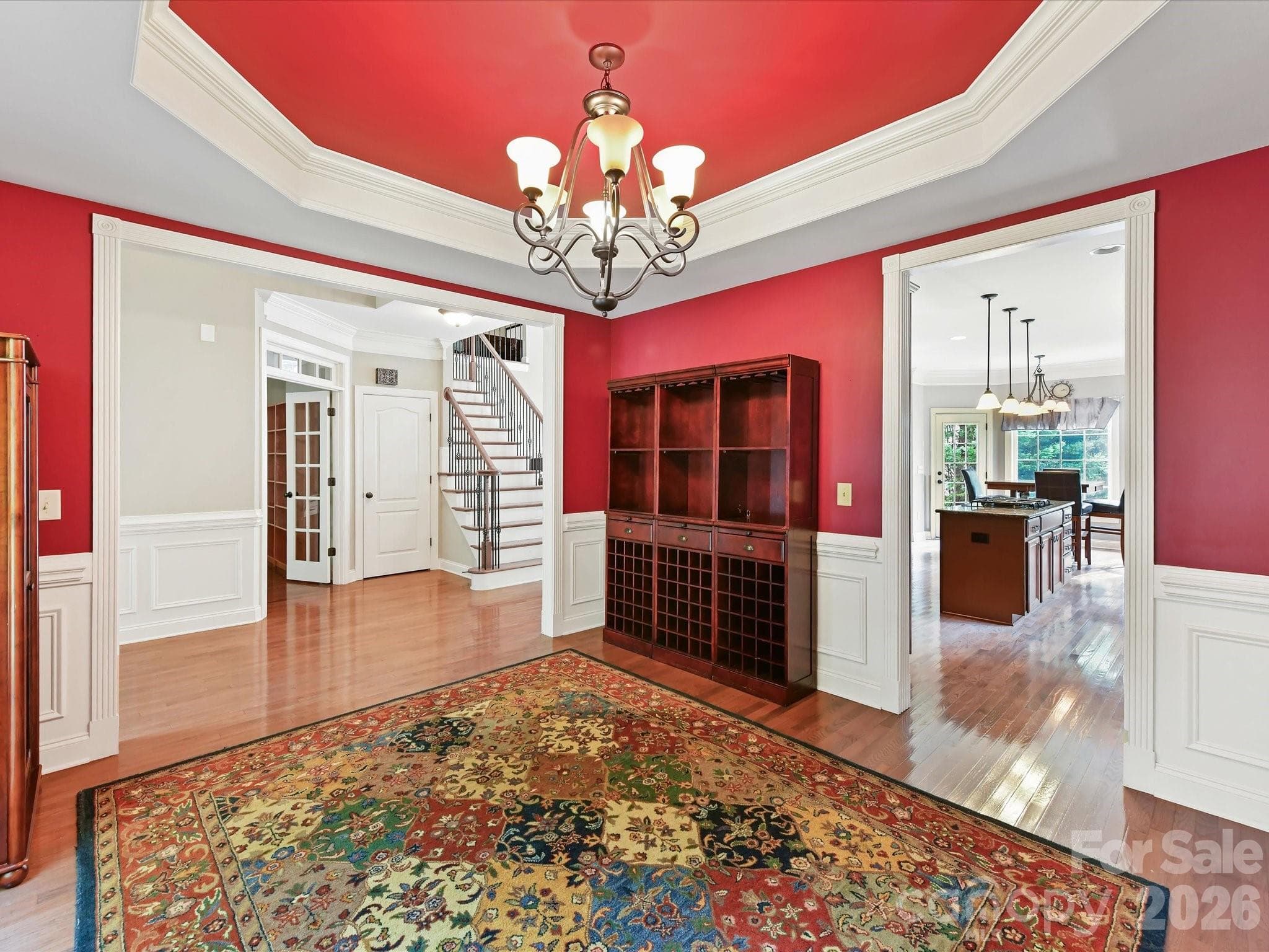 Spacious formal dining room featuring elegant trim, hardwood floors, and easy access to the kitchen for entertaining. - 11203 Warfield Avenue, Huntersville