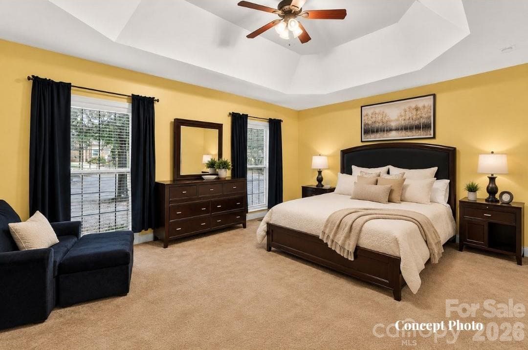 CONCEPT PHOTO - Generously sized primary suite featuring a dramatic tray ceiling, multiple windows, and plenty of room for a sitting area. - 11203 Warfield Avenue, Huntersville