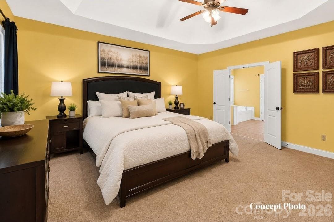CONCEPT PHOTO - Generously sized primary suite featuring a dramatic tray ceiling, multiple windows, and plenty of room for a sitting area. - 11203 Warfield Avenue, Huntersville