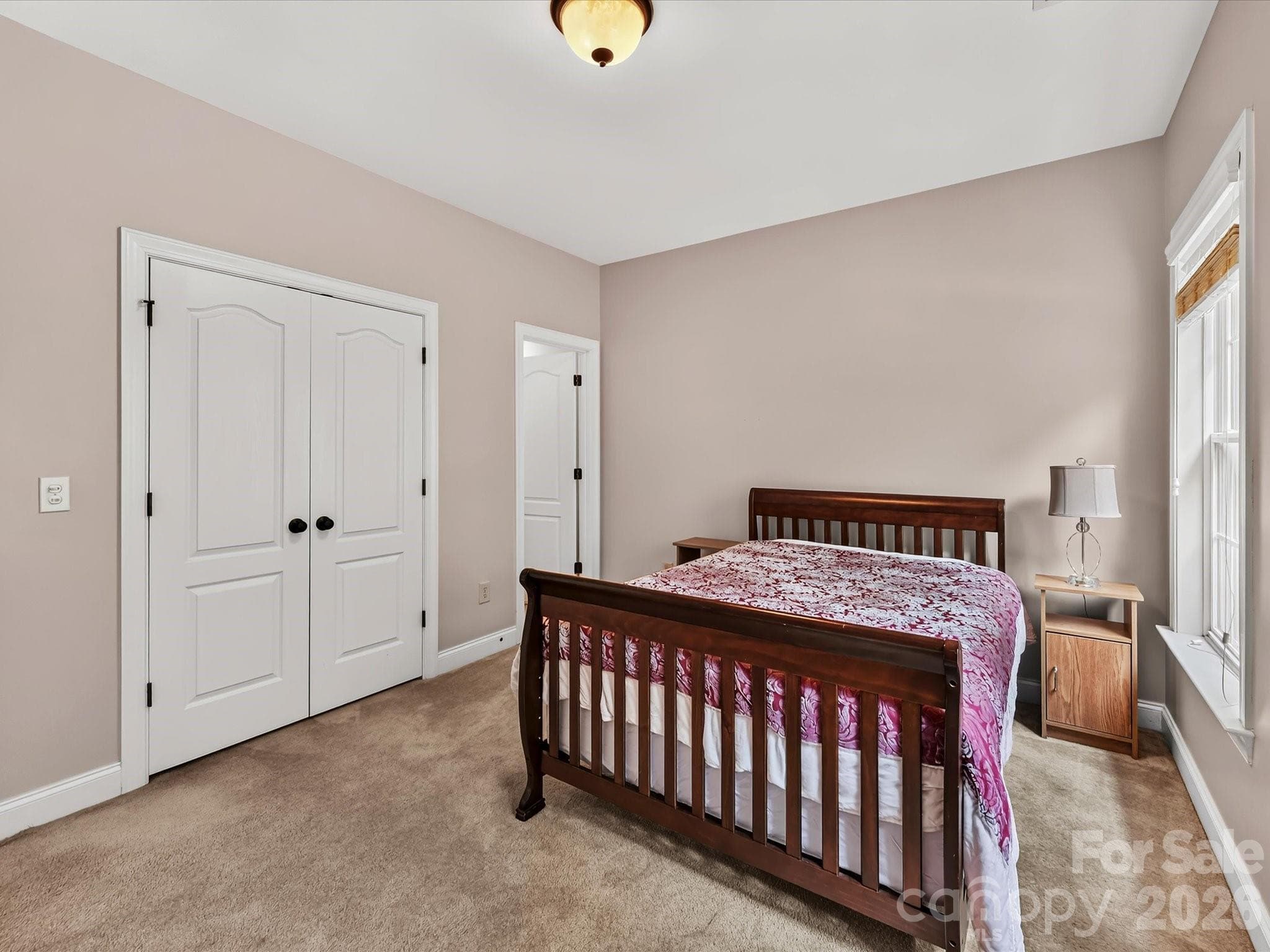 Bright secondary bedroom offers generous space, ample natural light, and convenient access to an adjoining bathroom. - 11203 Warfield Avenue, Huntersville