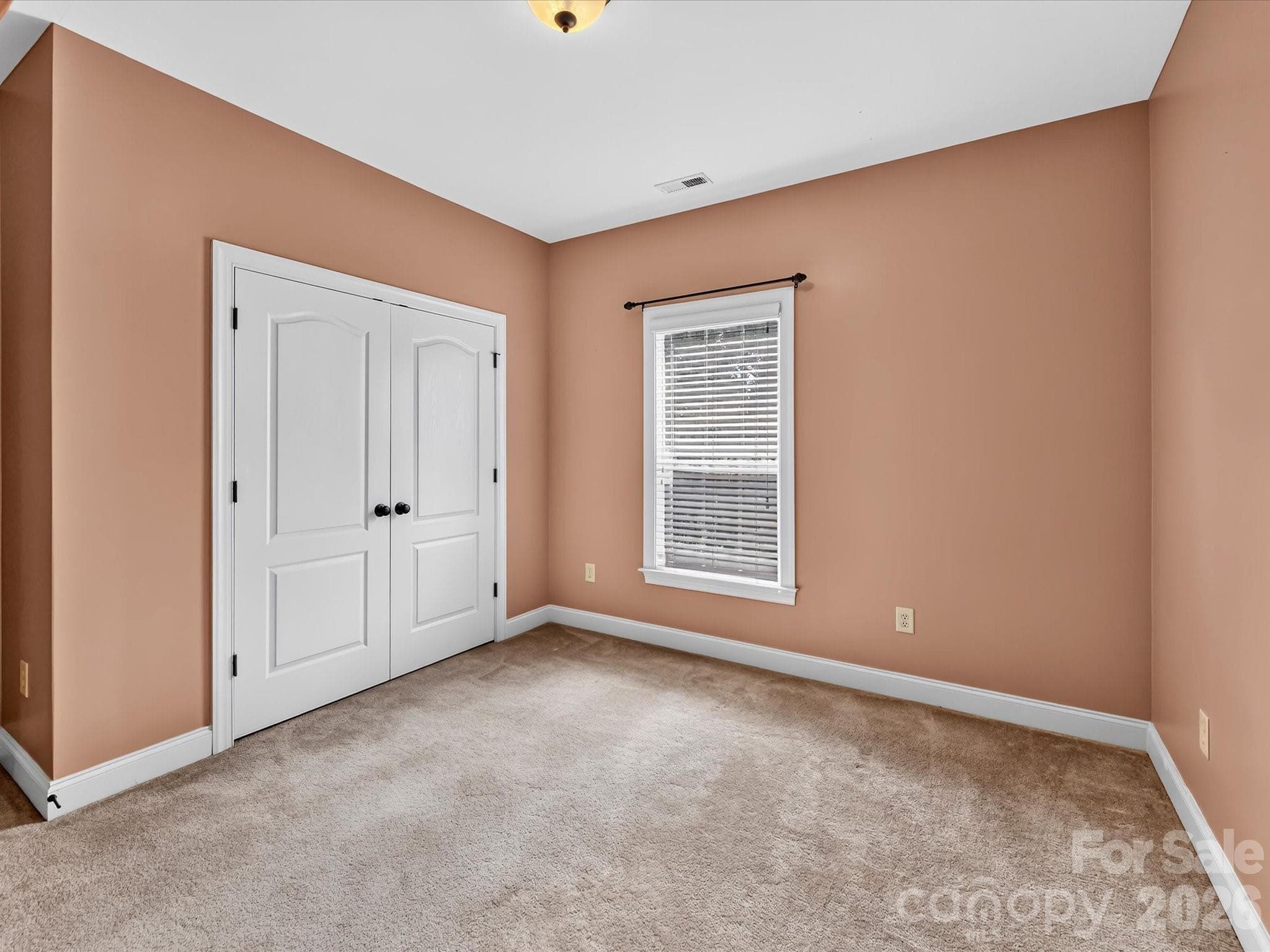 Additional bedroom provides versatile space for guests, family, a home office, or hobby room. - 11203 Warfield Avenue, Huntersville