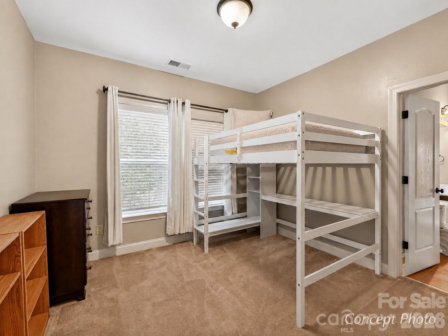 Spacious secondary bedroom offers flexible furniture placement, generous closet space, and convenient bathroom access. - 11203 Warfield Avenue, Huntersville