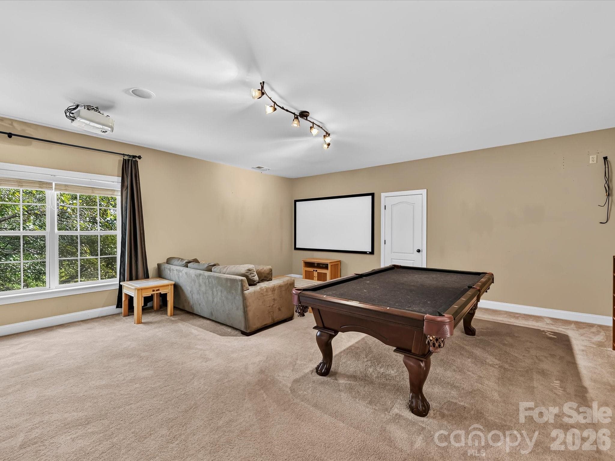 Oversized bonus room offers exceptional flexibility for a media room, game room, playroom, or additional lounge space. - 11203 Warfield Avenue, Huntersville
