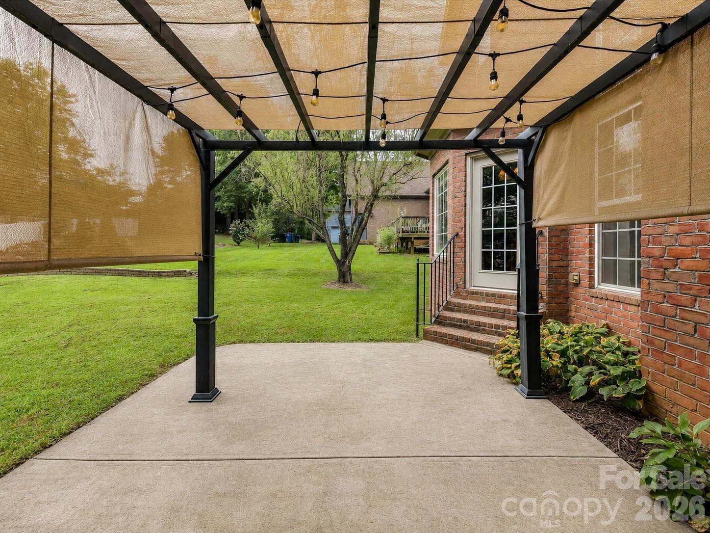 Covered patio and pergola-style outdoor living area create a great space for relaxing, dining, and entertaining outdoors. - 11203 Warfield Avenue, Huntersville