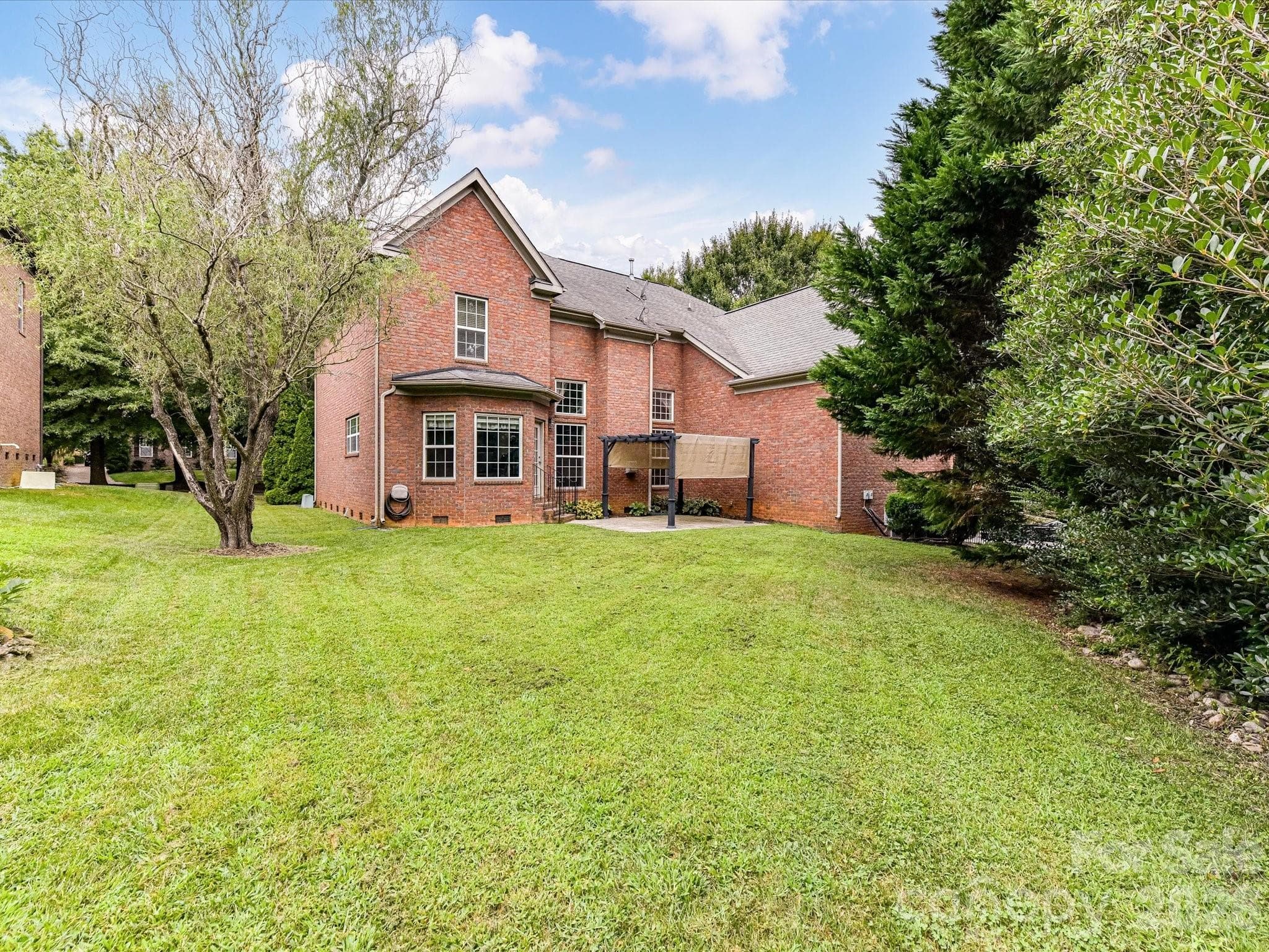 Spacious backyard with mature landscaping offers plenty of room for outdoor recreation, entertaining, or gardening. - 11203 Warfield Avenue, Huntersville