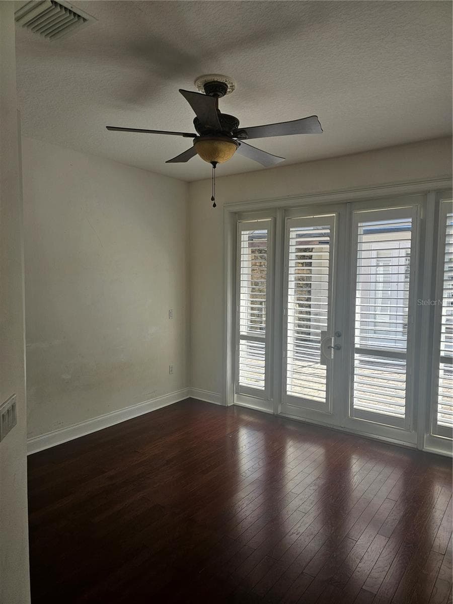 Double doors with Bermuda blinds leading to courtyard - 33116 IRONGATE DR, LEESBURG