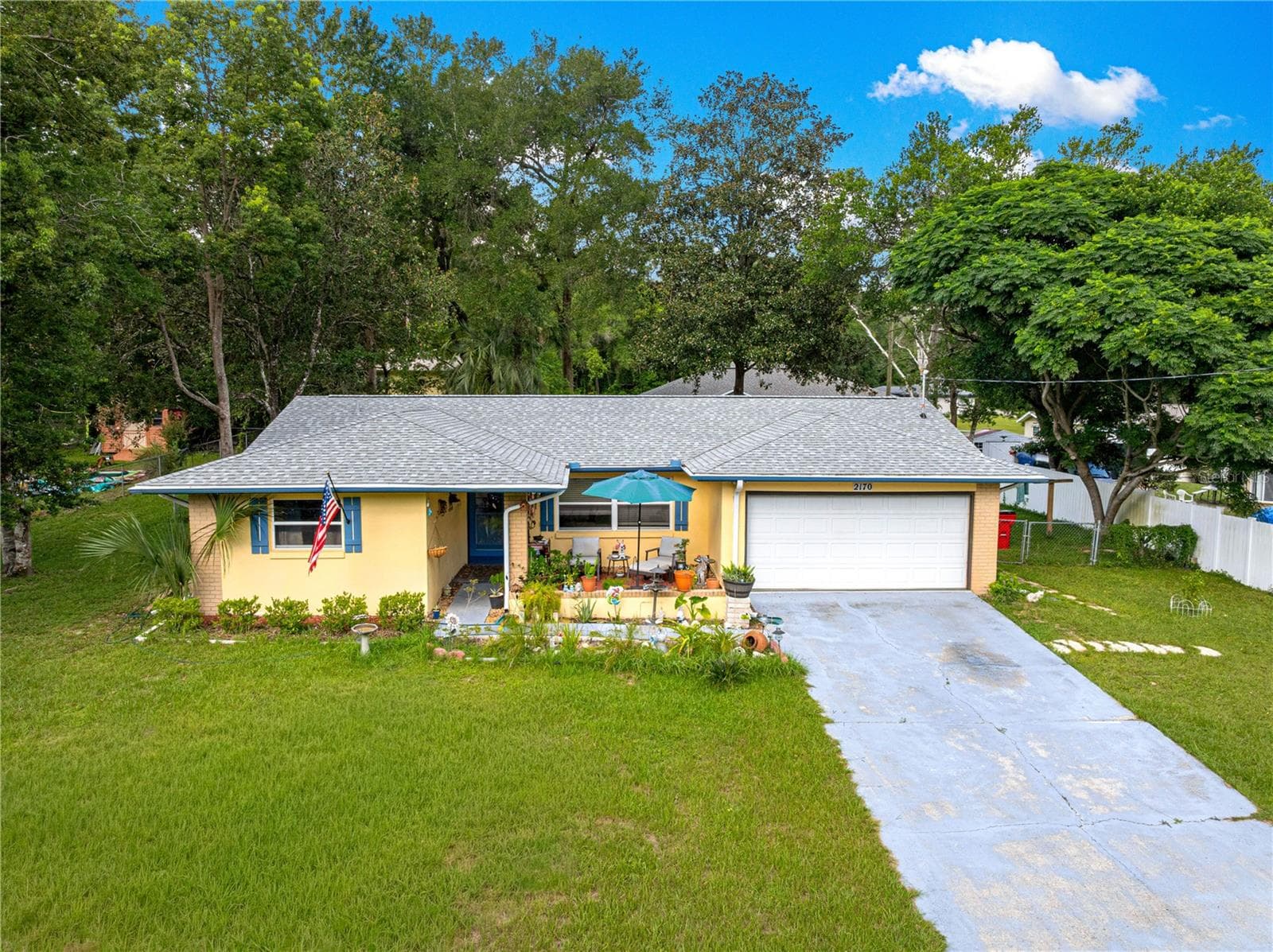 Front elevation showing the single-story layout and two-car garage. - 2170 W DORAL CT, CITRUS SPRINGS