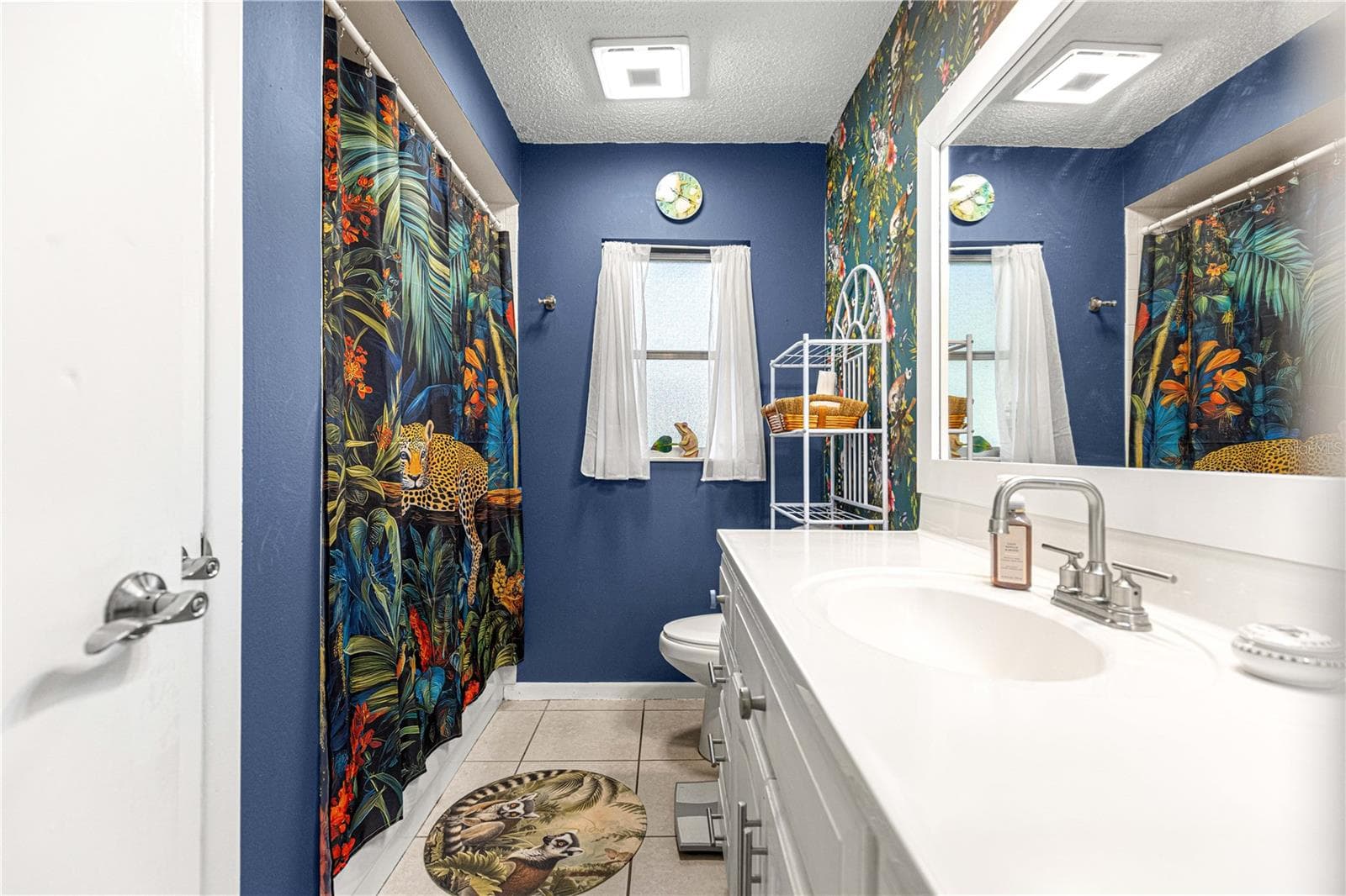 Second bathroom with a long vanity, storage and a window. - 2170 W DORAL CT, CITRUS SPRINGS