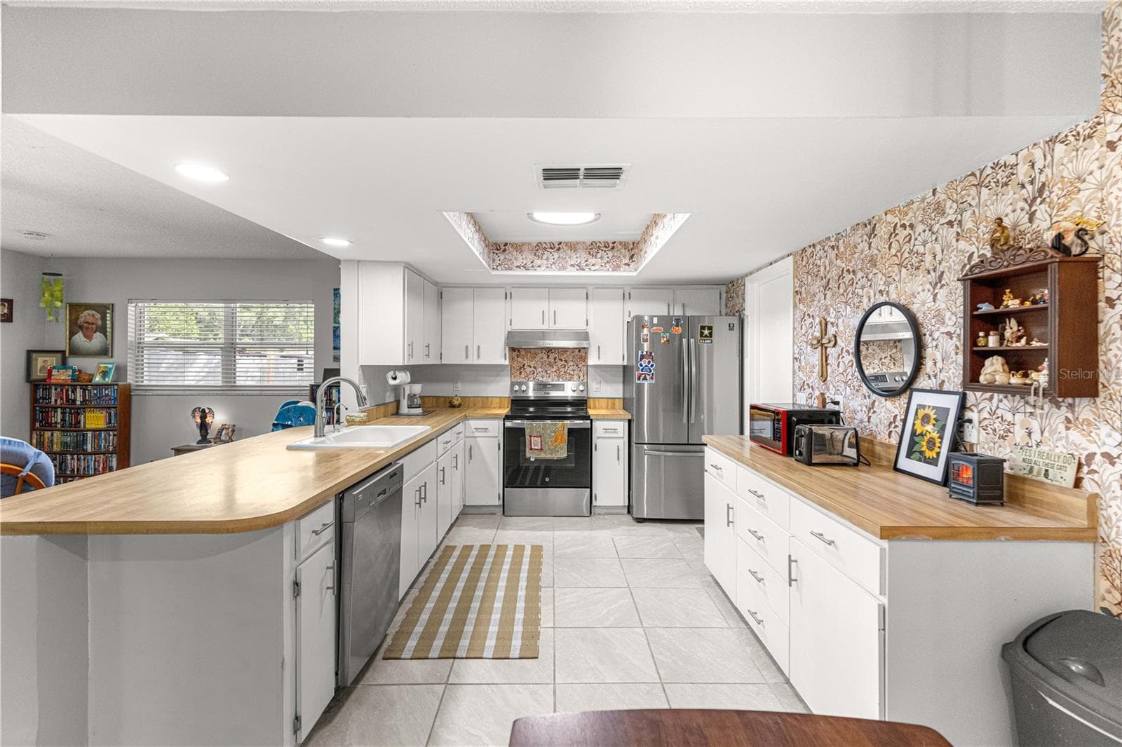Kitchen layout showing cabinet storage, stainless-steel appliances and the breakfast bar. - 2170 W DORAL CT, CITRUS SPRINGS