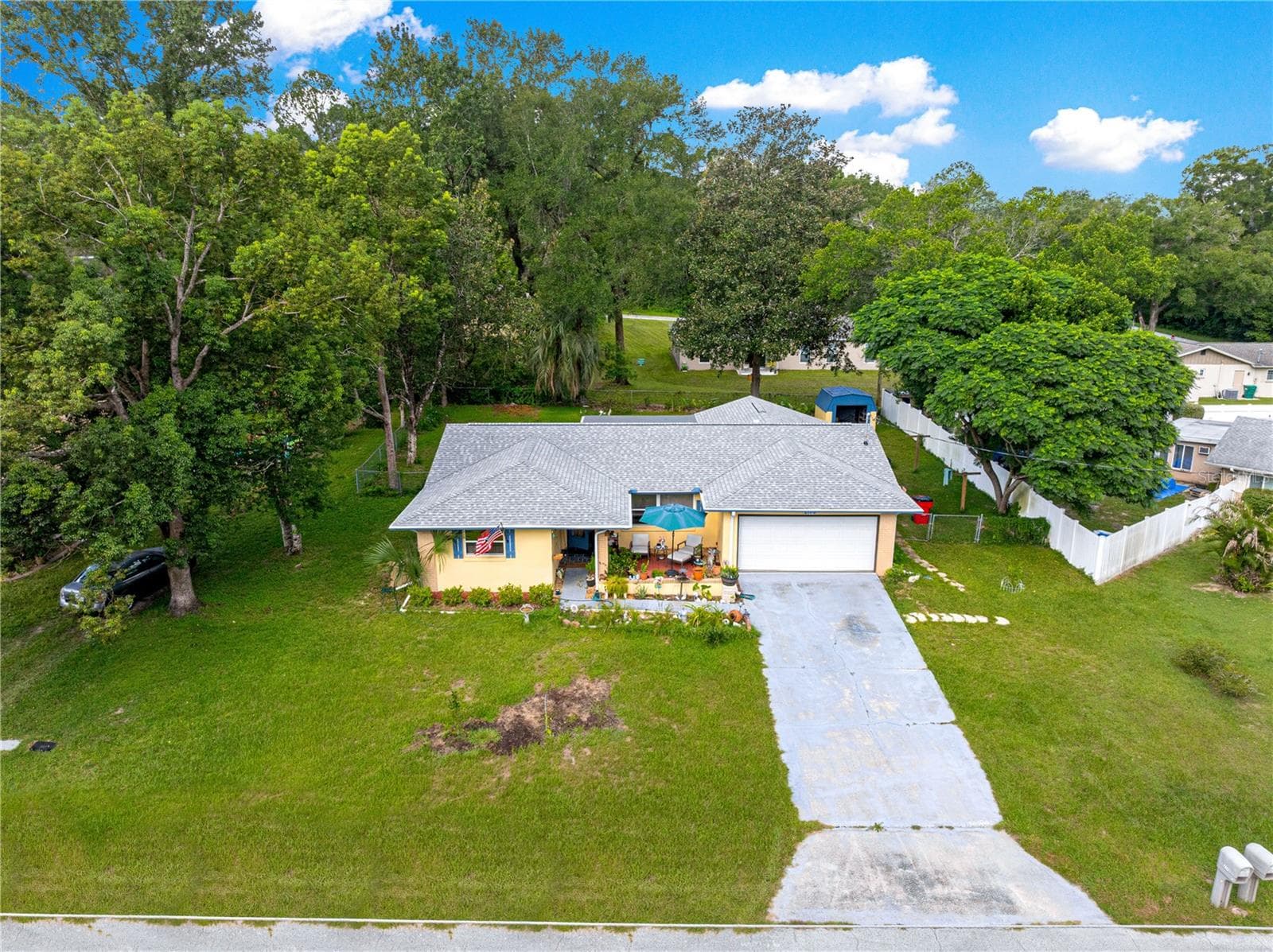Elevated front view of the home, driveway and surrounding trees. - 2170 W DORAL CT, CITRUS SPRINGS