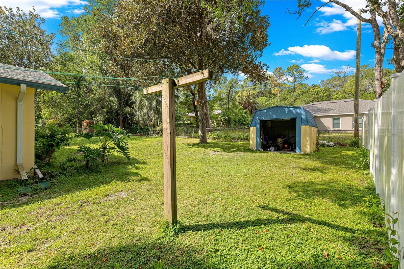 Backyard with a storage shed for tools and outdoor equipment. - 2170 W DORAL CT, CITRUS SPRINGS