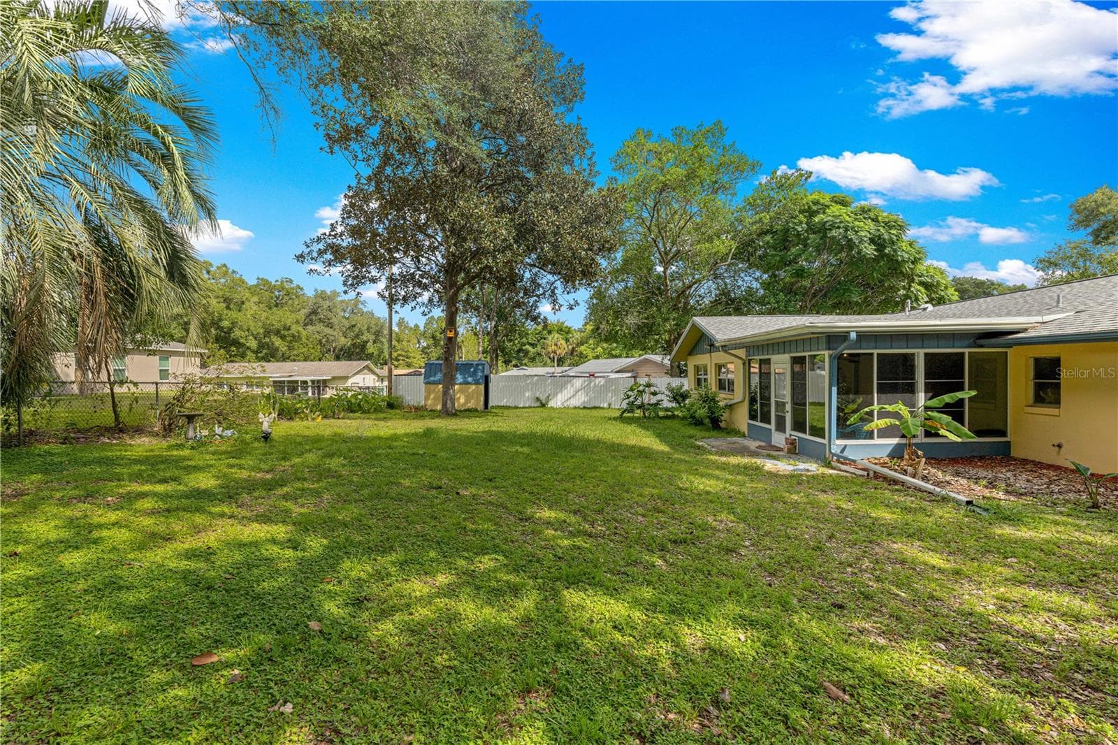Backyard view toward the home and enclosed rear porch. - 2170 W DORAL CT, CITRUS SPRINGS