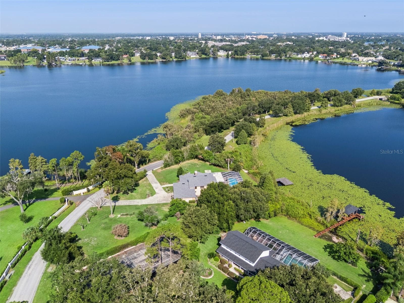 Aerial view showcasing the beautiful chain of lakes surrounding the area, highlighting the home’s exceptional lakefront setting and the natural beauty of its surroundings. - 25 LAKEWOOD CSWY, WINTER HAVEN