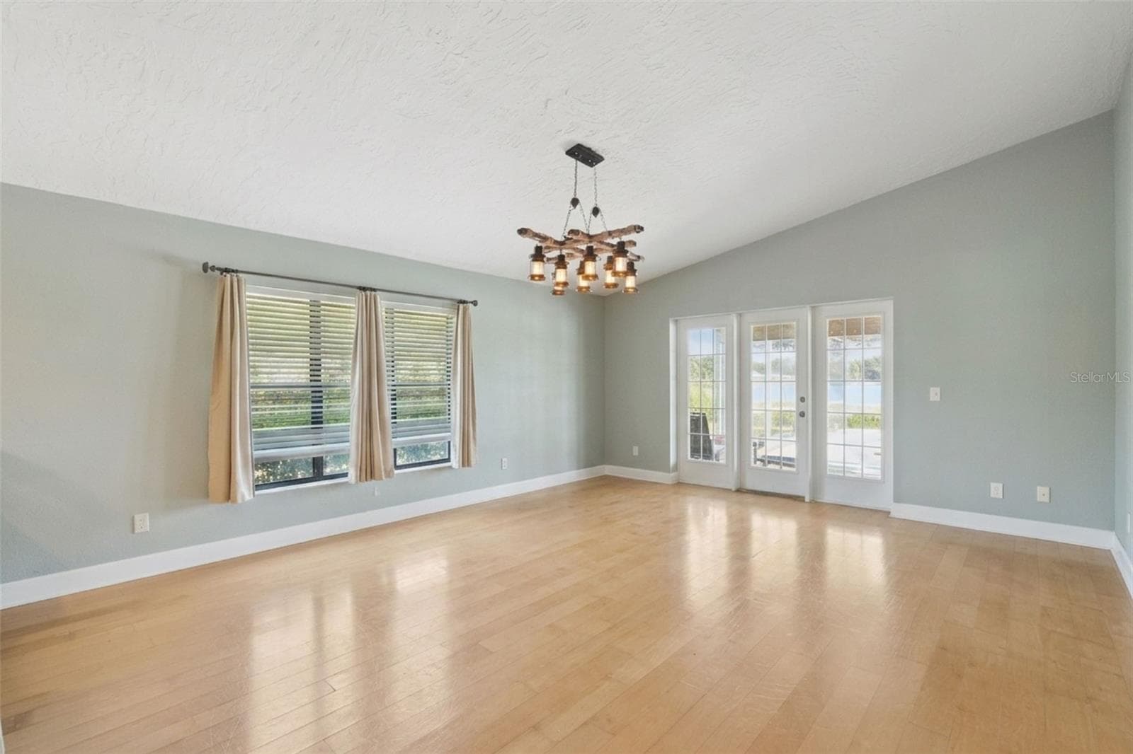 Dining room featuring beautiful glass windowed doors leading to the patio and pool. - 25 LAKEWOOD CSWY, WINTER HAVEN