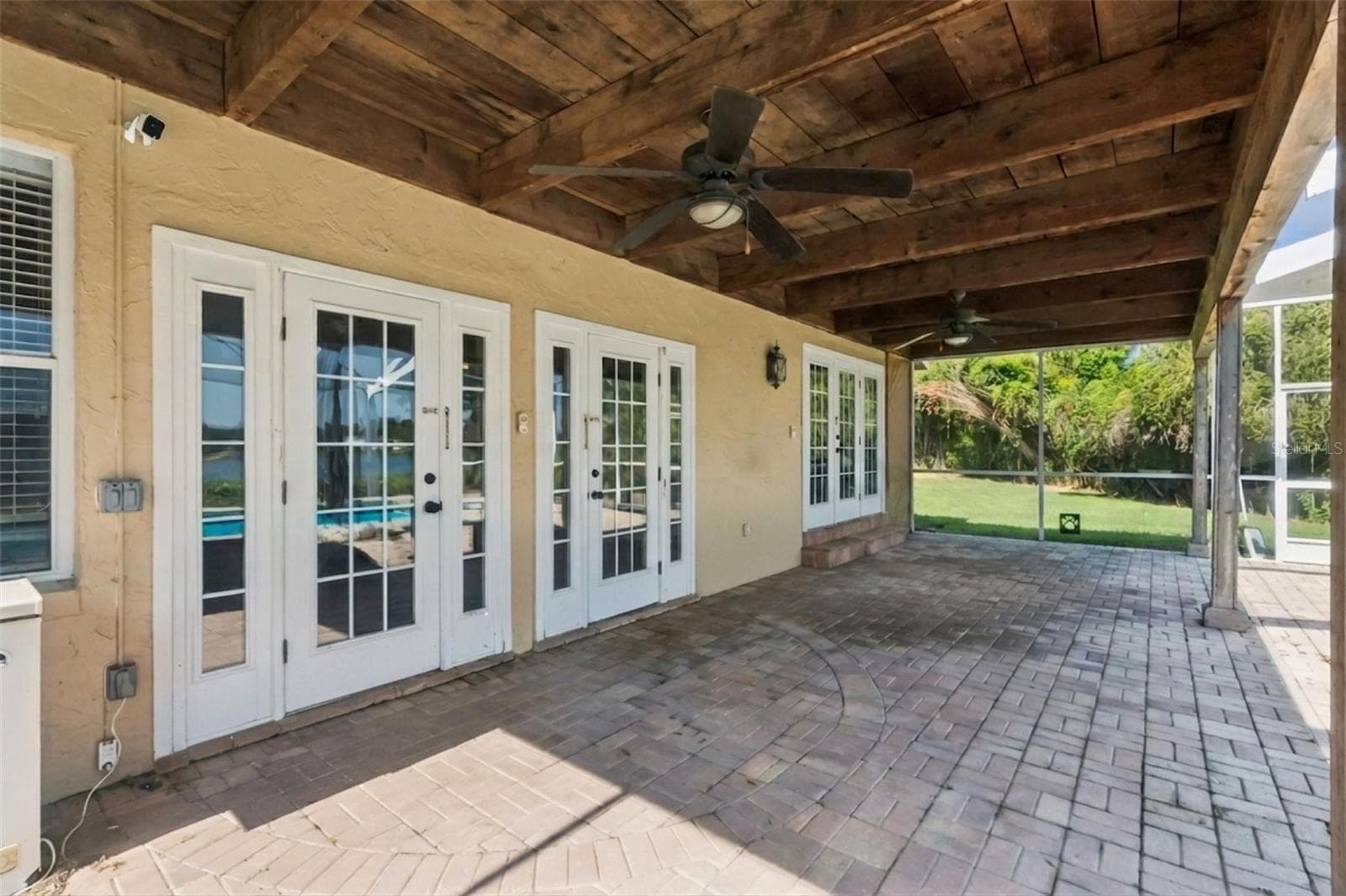 Relaxing covered paver outdoor patio next to the pool with double doors to the family room and the dining room. - 25 LAKEWOOD CSWY, WINTER HAVEN
