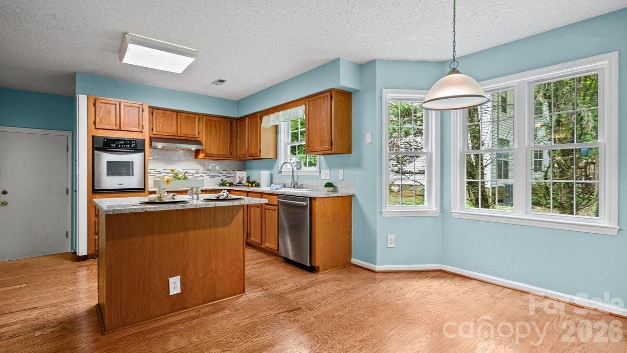 Kitchen with access to porch and dining area - 235 Withershinn Drive, Charlotte