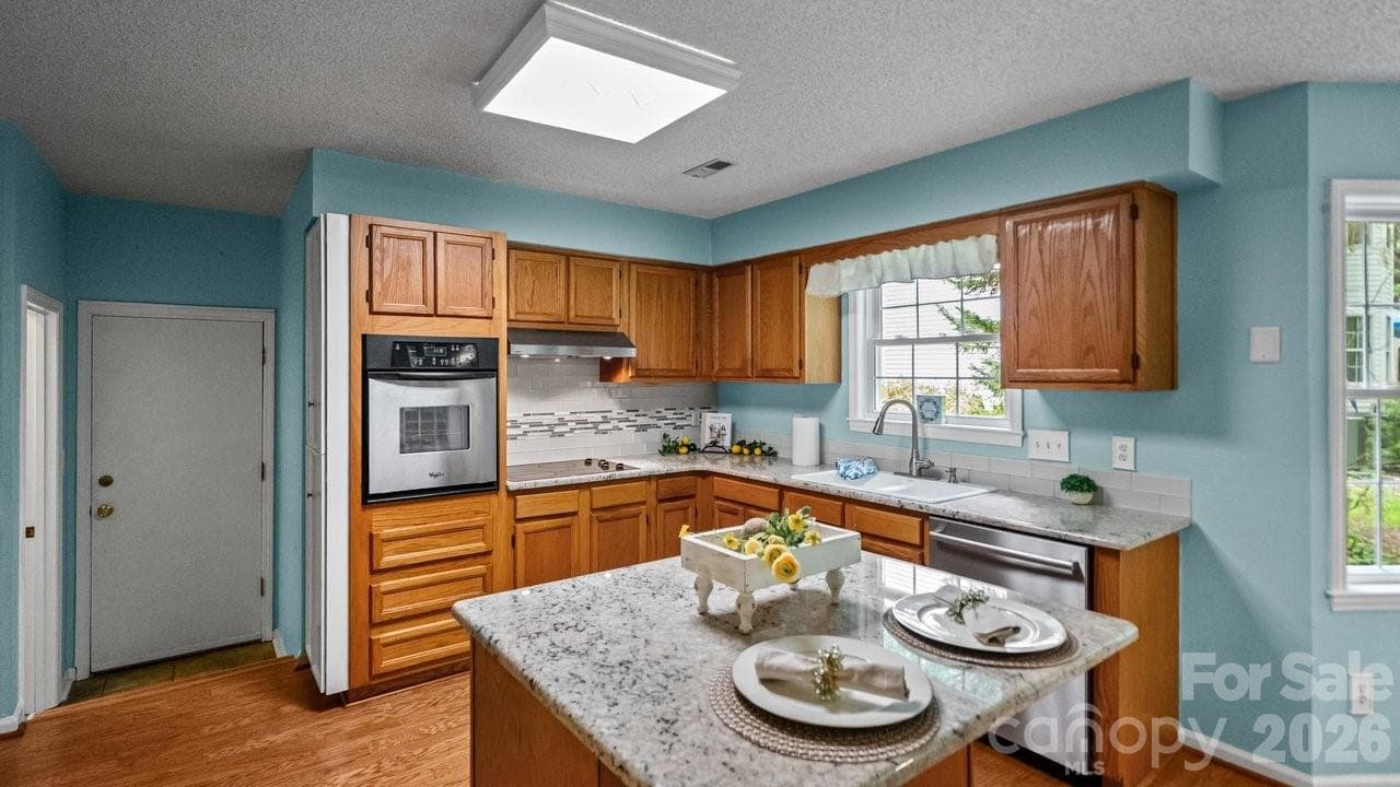 granite countertops and tile backsplash - 235 Withershinn Drive, Charlotte