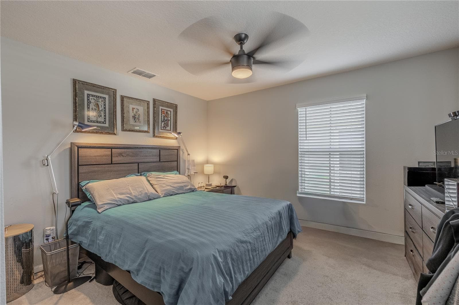 Bedroom 3 offers generous proportions, neutral carpet, a ceiling fan and a large window, with plenty of room for a full bedroom suite and additional furniture. - 3029 JACOB CROSSING LN, HOLIDAY