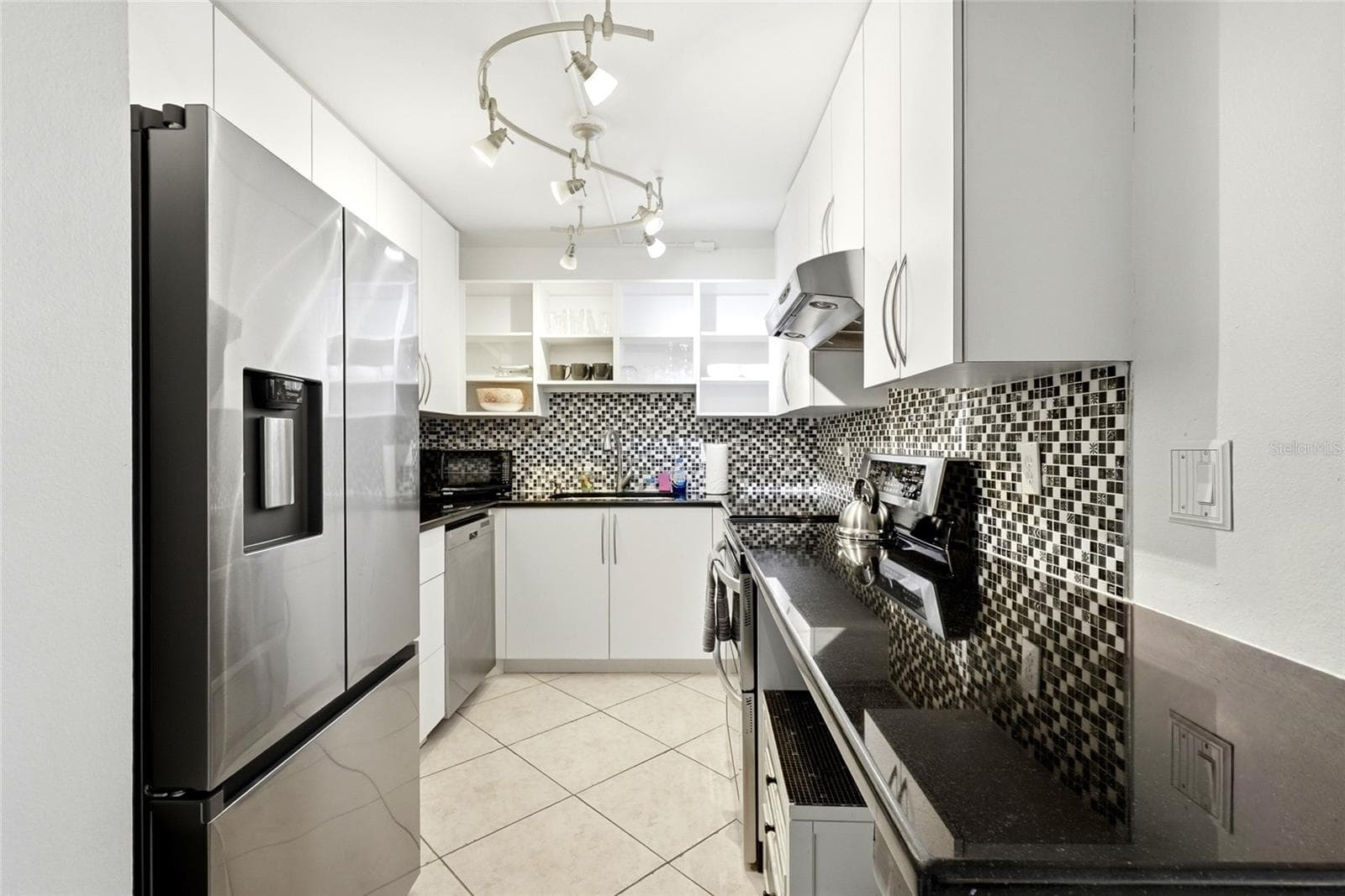 Kitchen - Washer and dryer plug ins available underneath counter across from fridge - 5855 MIDNIGHT PASS RD #222, SARASOTA