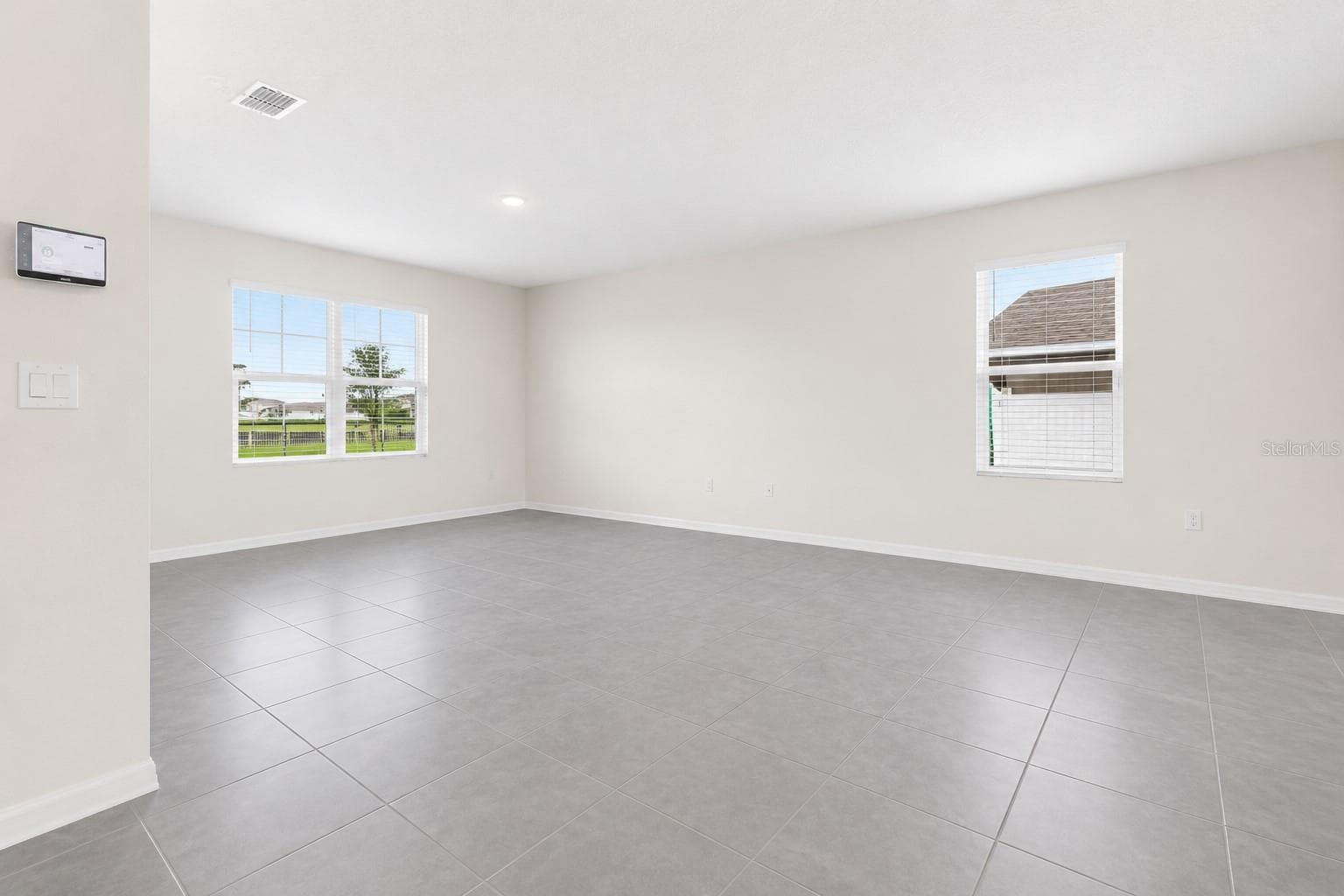 Spacious main living area with ceramic tile flooring - 1021 SILVERBELL TRL, ST CLOUD