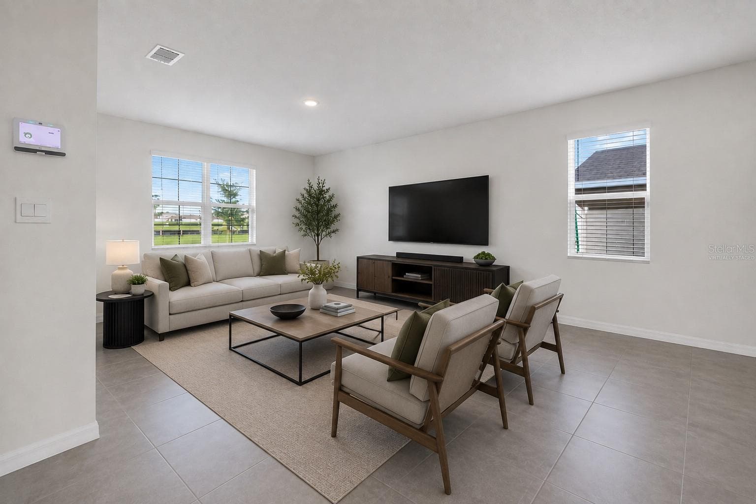 Virtually staged living room – open-concept main living area - 1021 SILVERBELL TRL, ST CLOUD