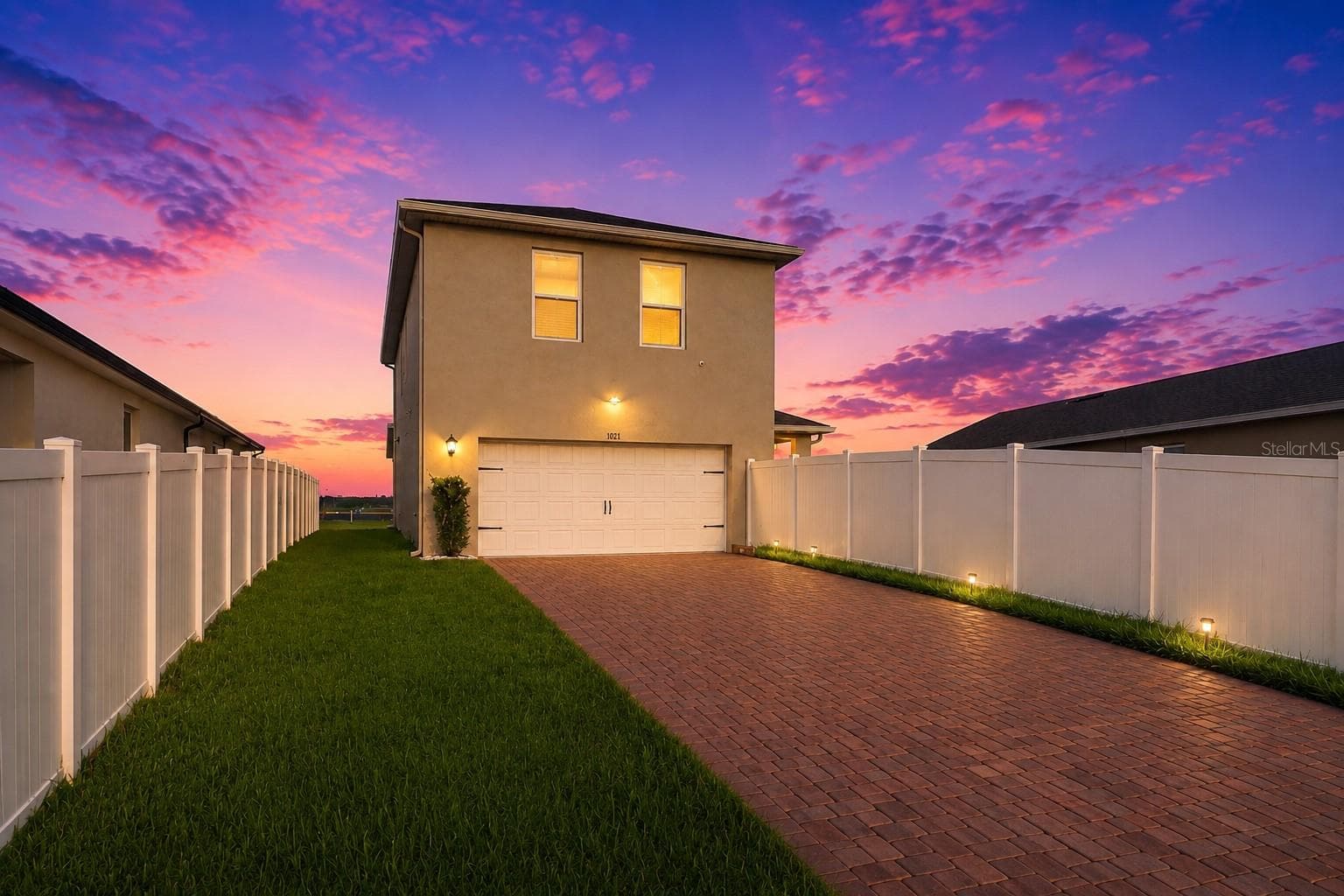 Rear Twilight View & Paver Driveway - 1021 SILVERBELL TRL, ST CLOUD