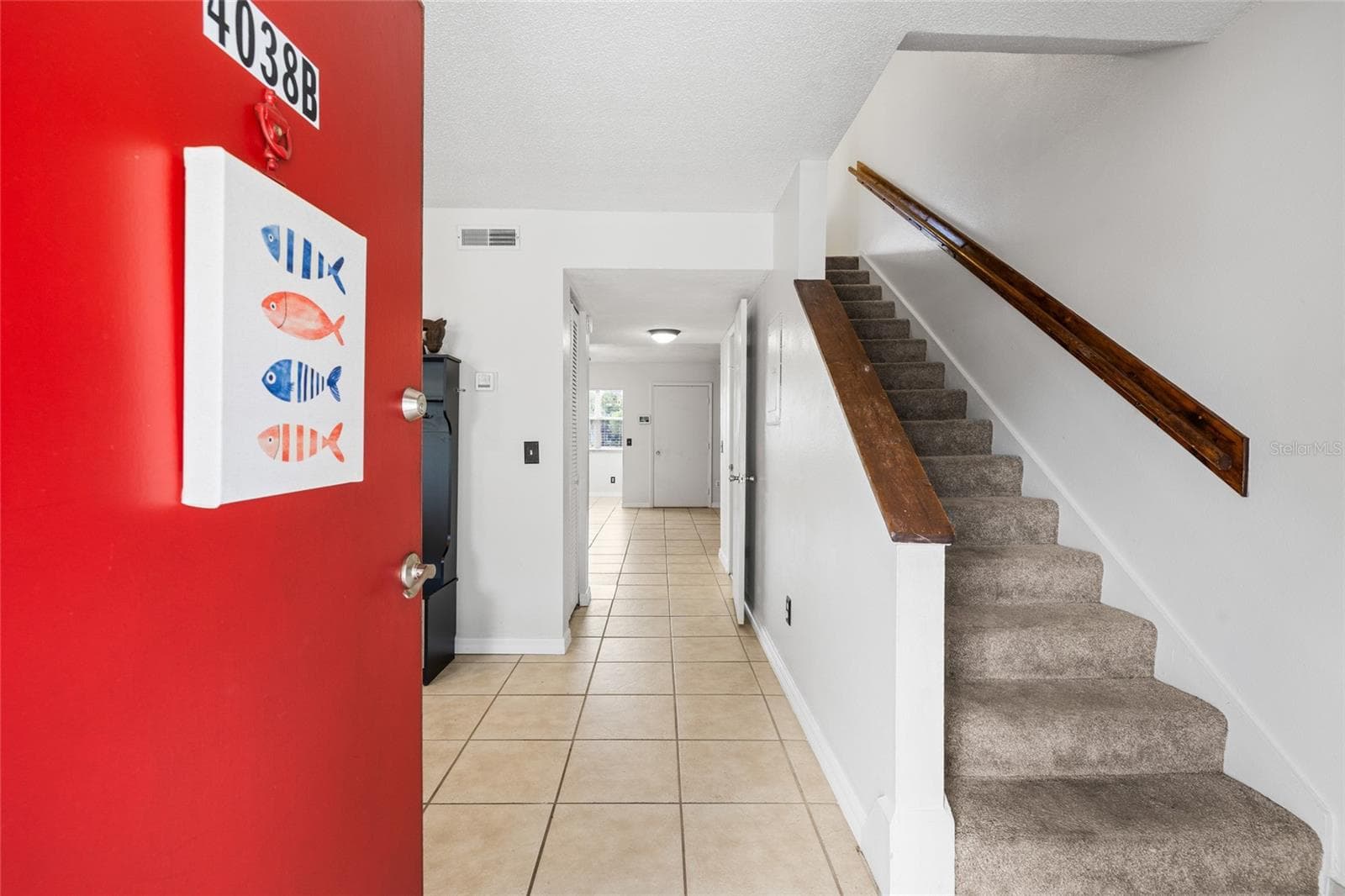 Entering the home, you will find a large room to the left which would make a great office or gaming space.  Stairs lead to two oversized bedrooms with en-suite baths. - 4038 CORTEZ DR #B, TAMPA