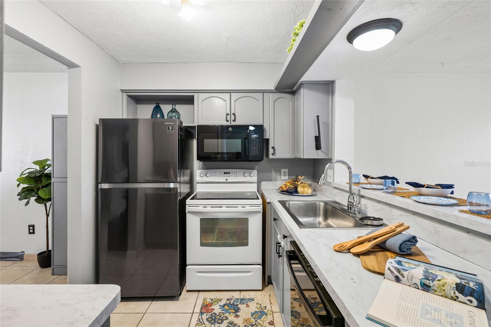 Breakfast bar opens to the living room. - 4038 CORTEZ DR #B, TAMPA
