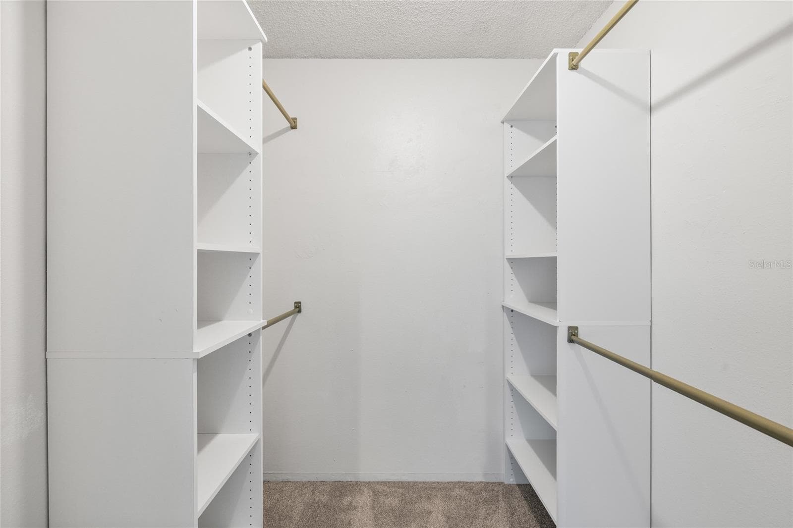 Primary bedroom walk in closet with tons of shelves and bars for all your clothes - 4038 CORTEZ DR #B, TAMPA